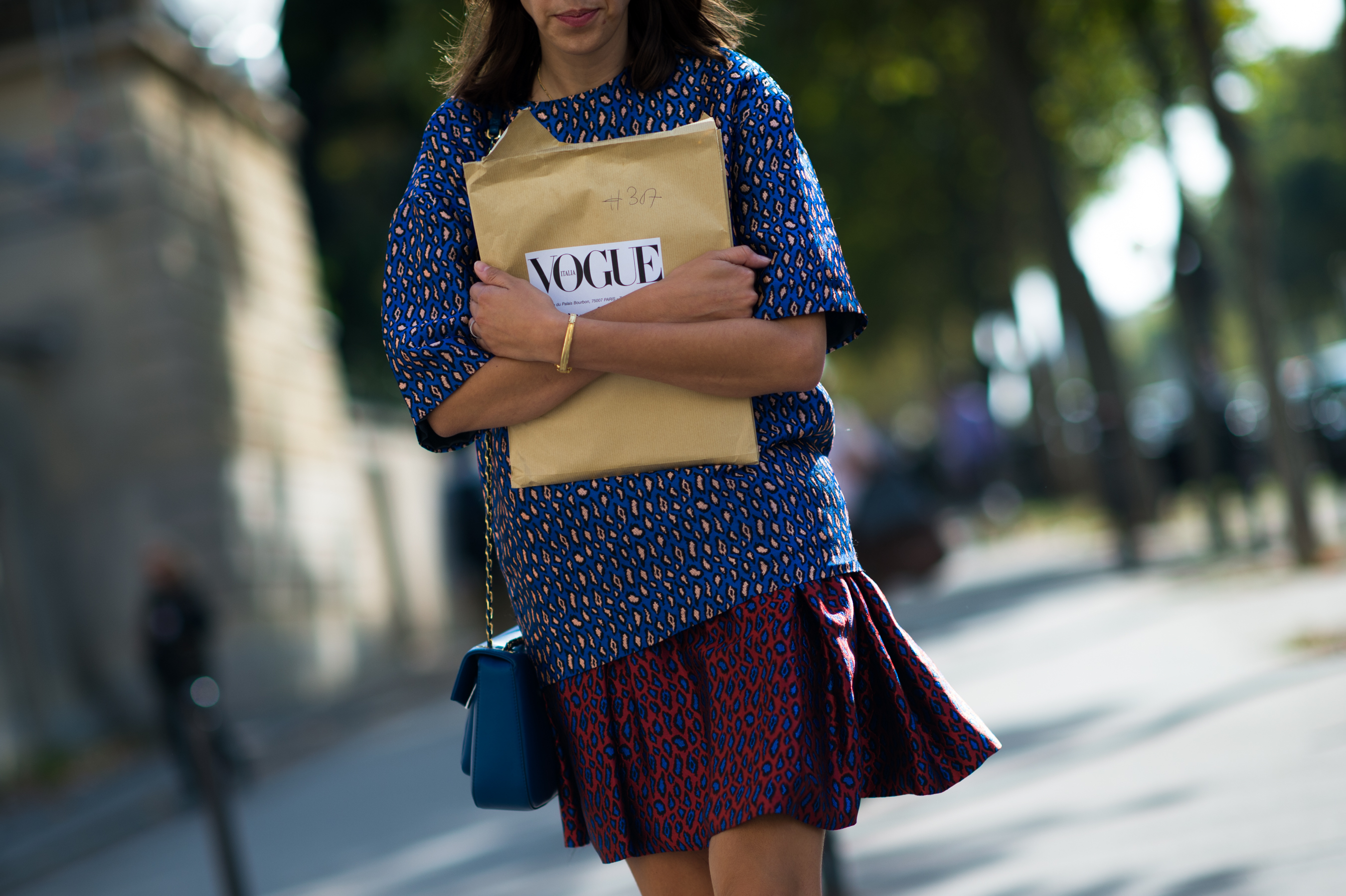 Italian Vogue editor carrying her magazine