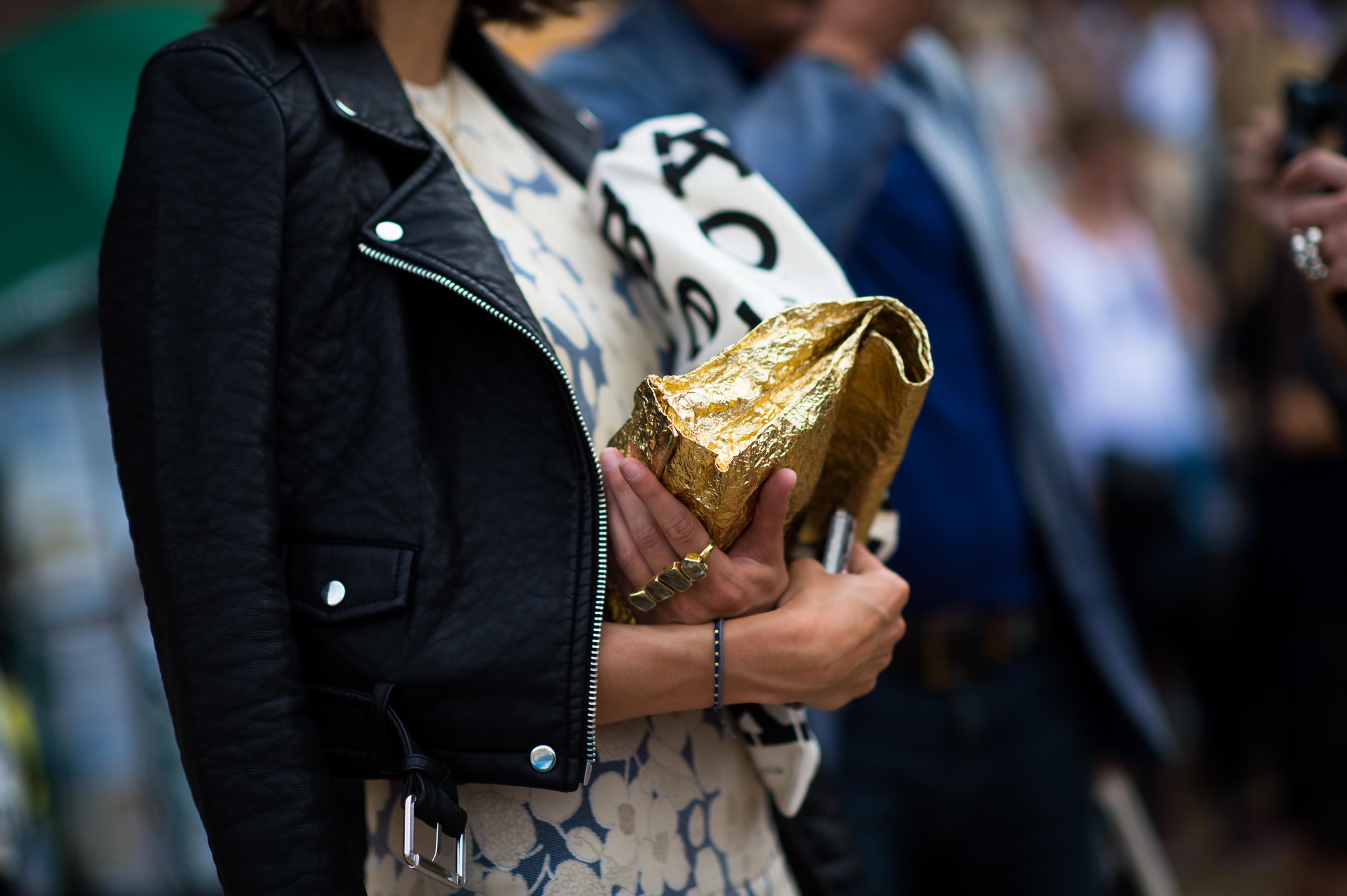 British woman holding gold bag