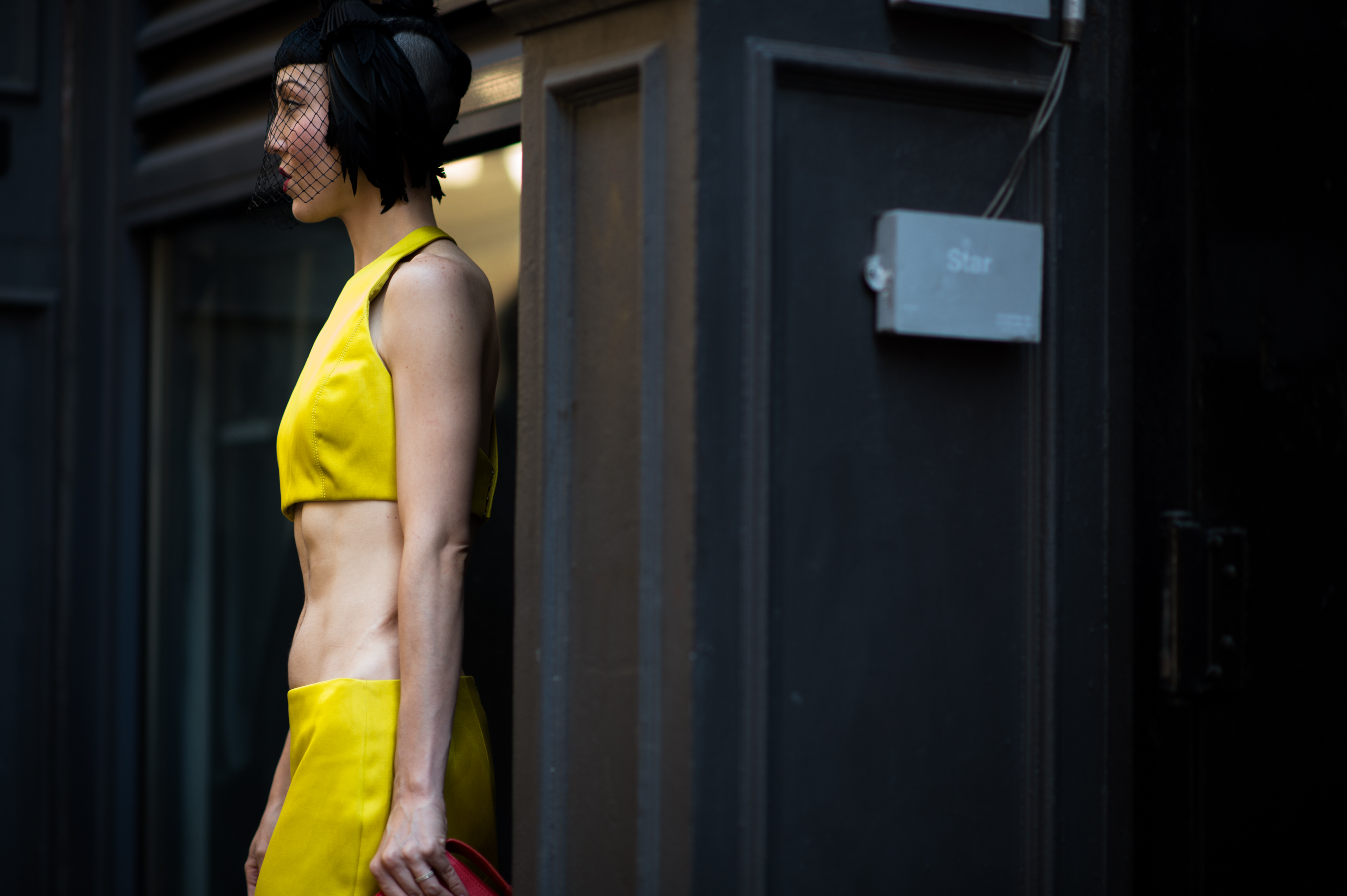 Woman wearing yellow cropped suit