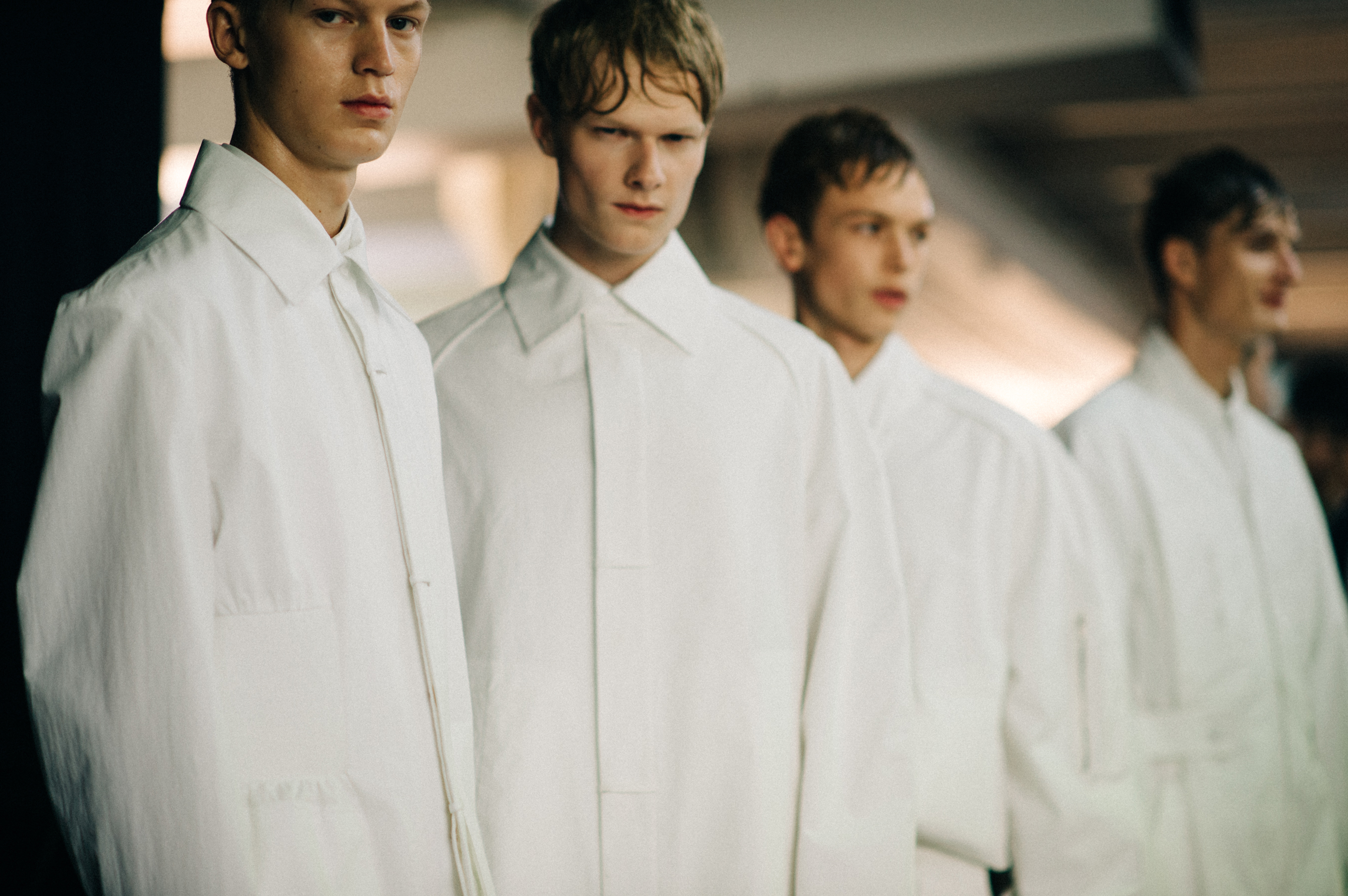 Four male models wearing all white