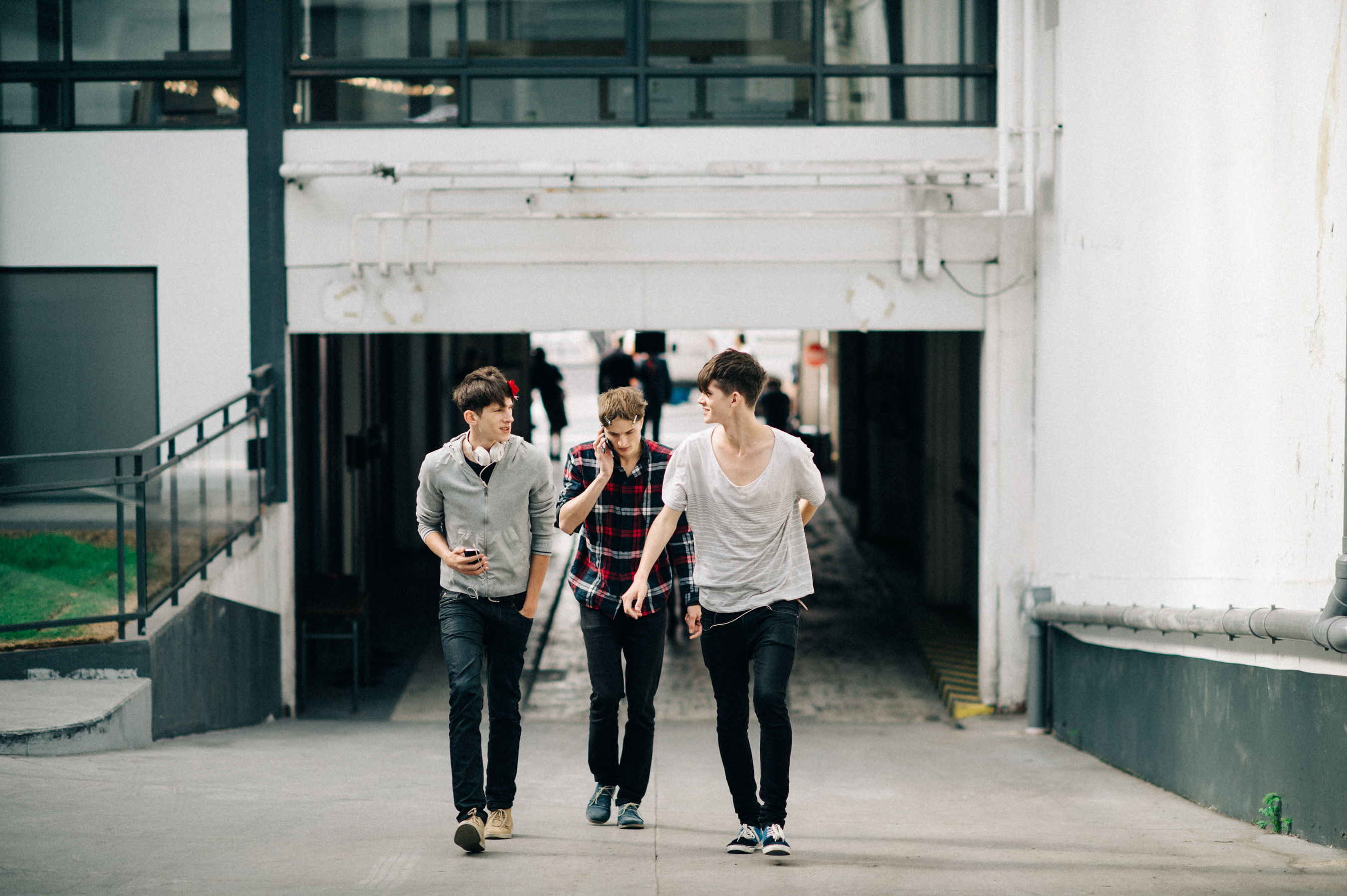 Three male models walking together