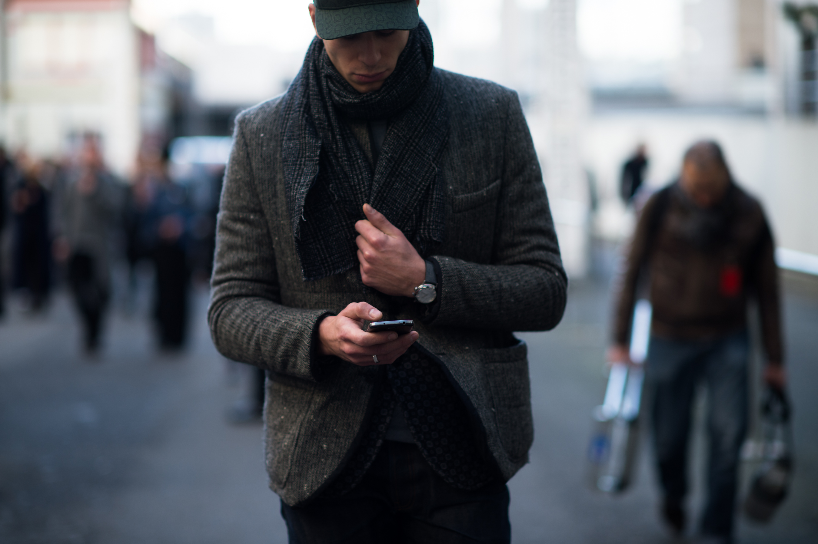 Man wearing earth tones texting