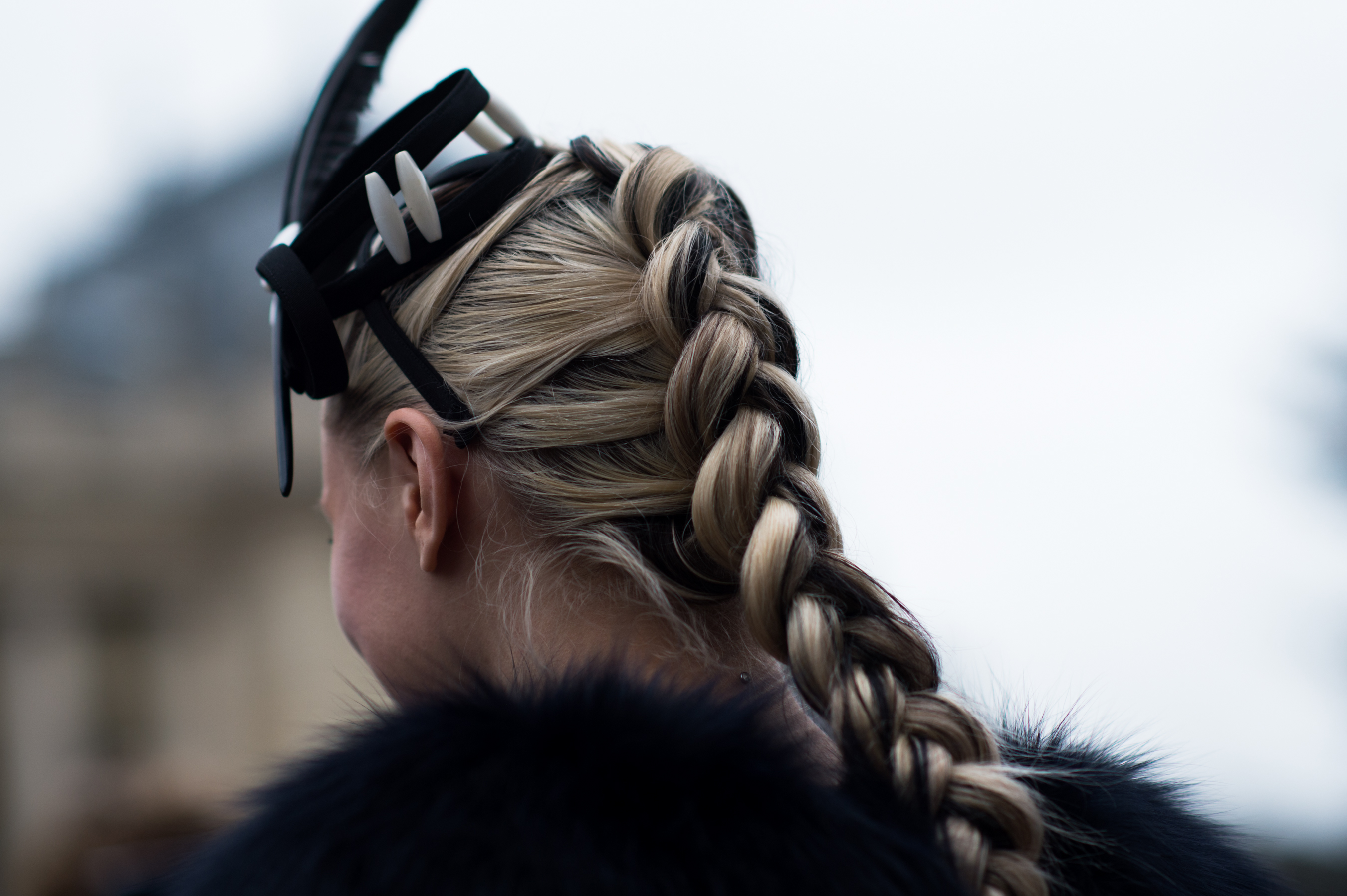 Woman with braid and a feather in her hair