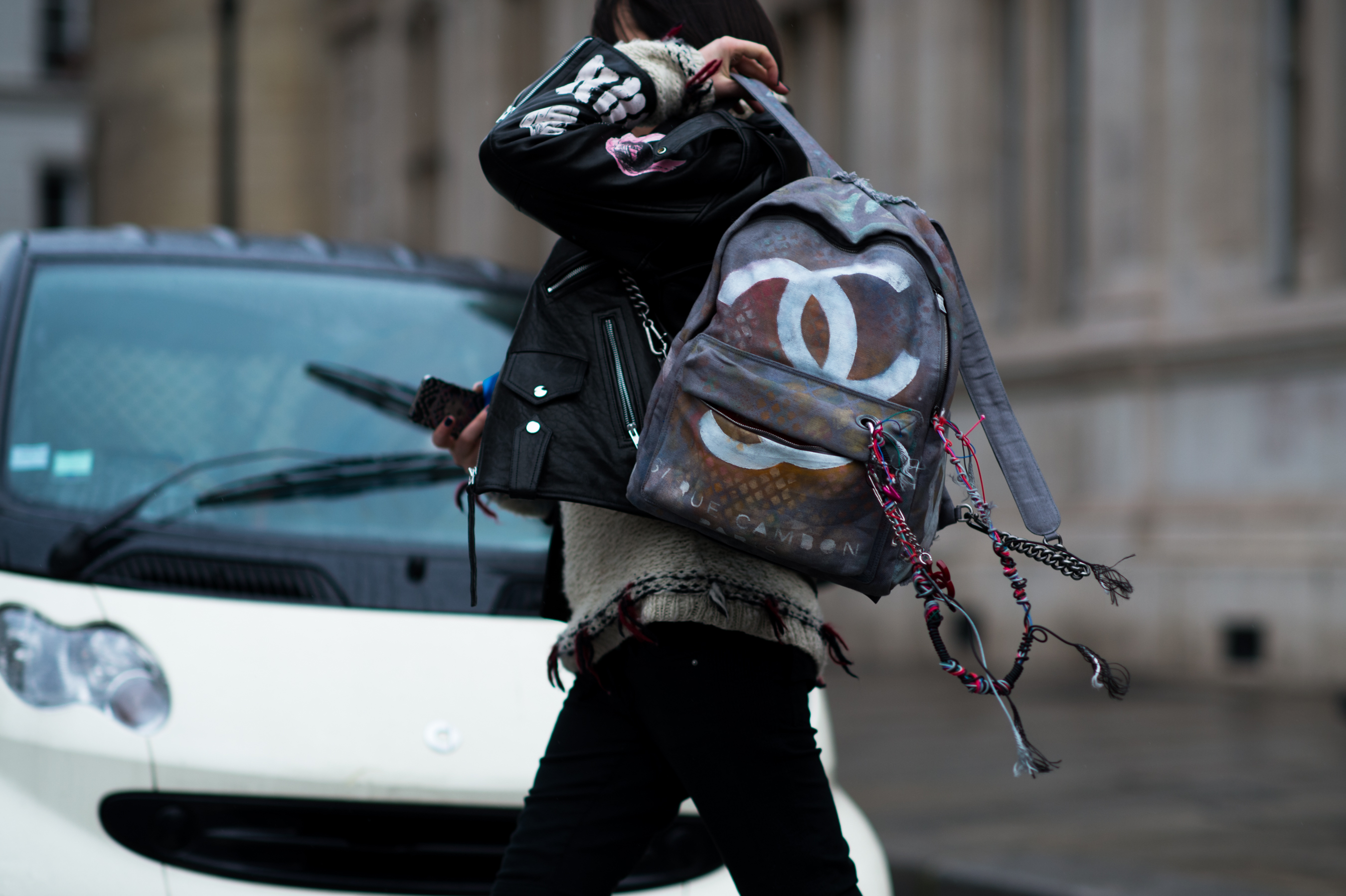 Woman wearing graffiti Chanel backpack