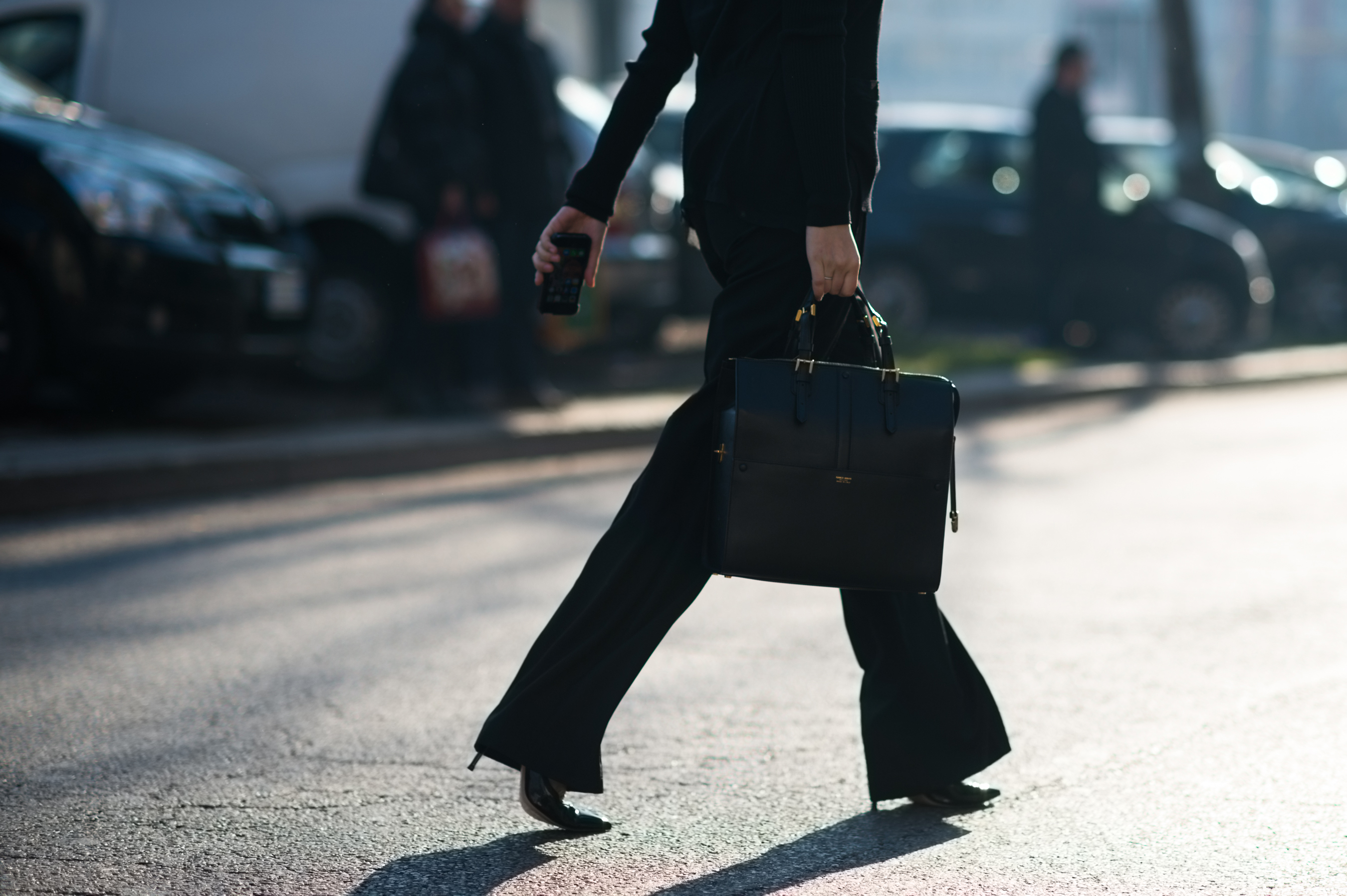 Woman wearing all black with a Giorgio Armani bag