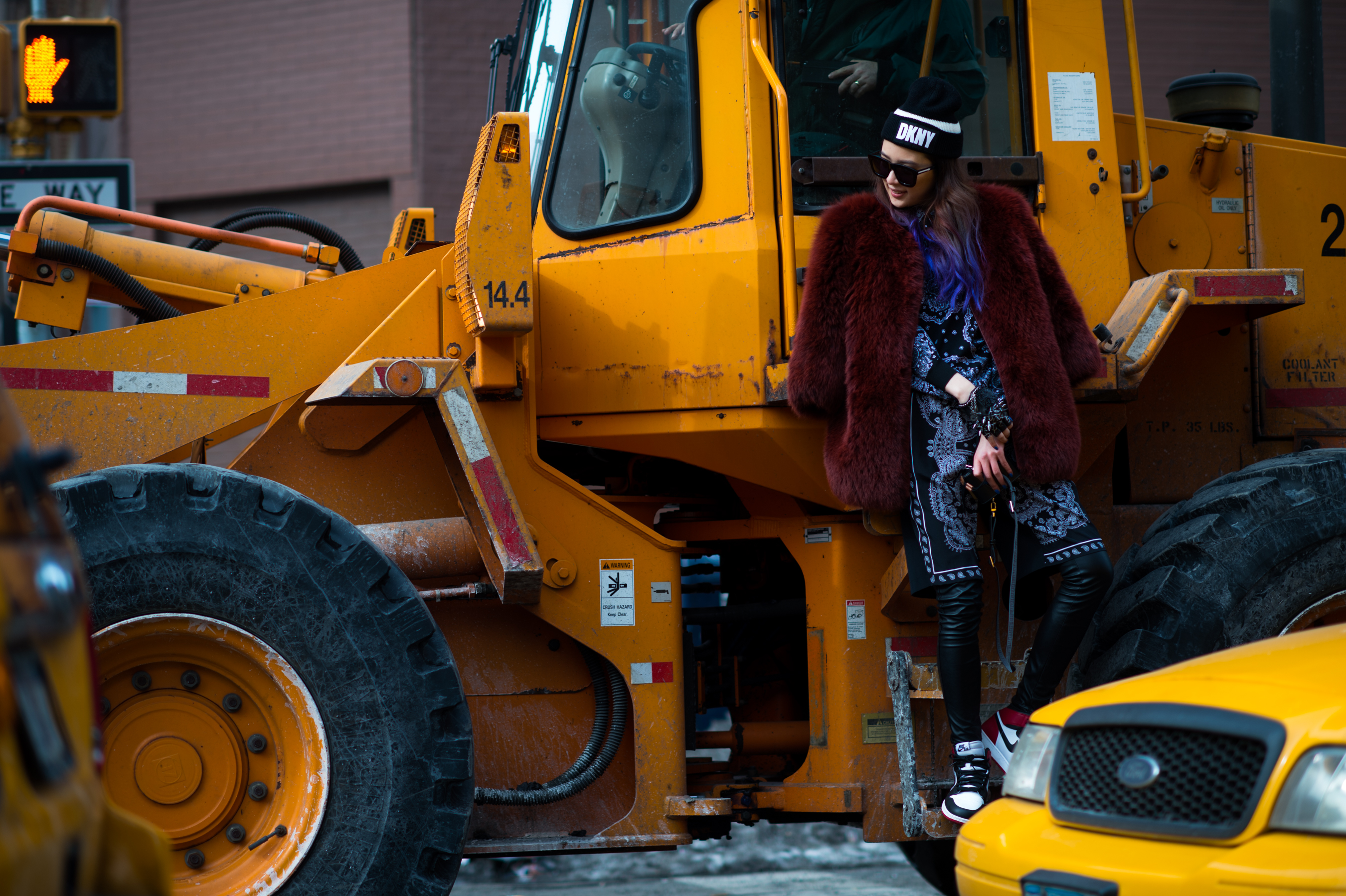 South Korean Model standing on construction equipment