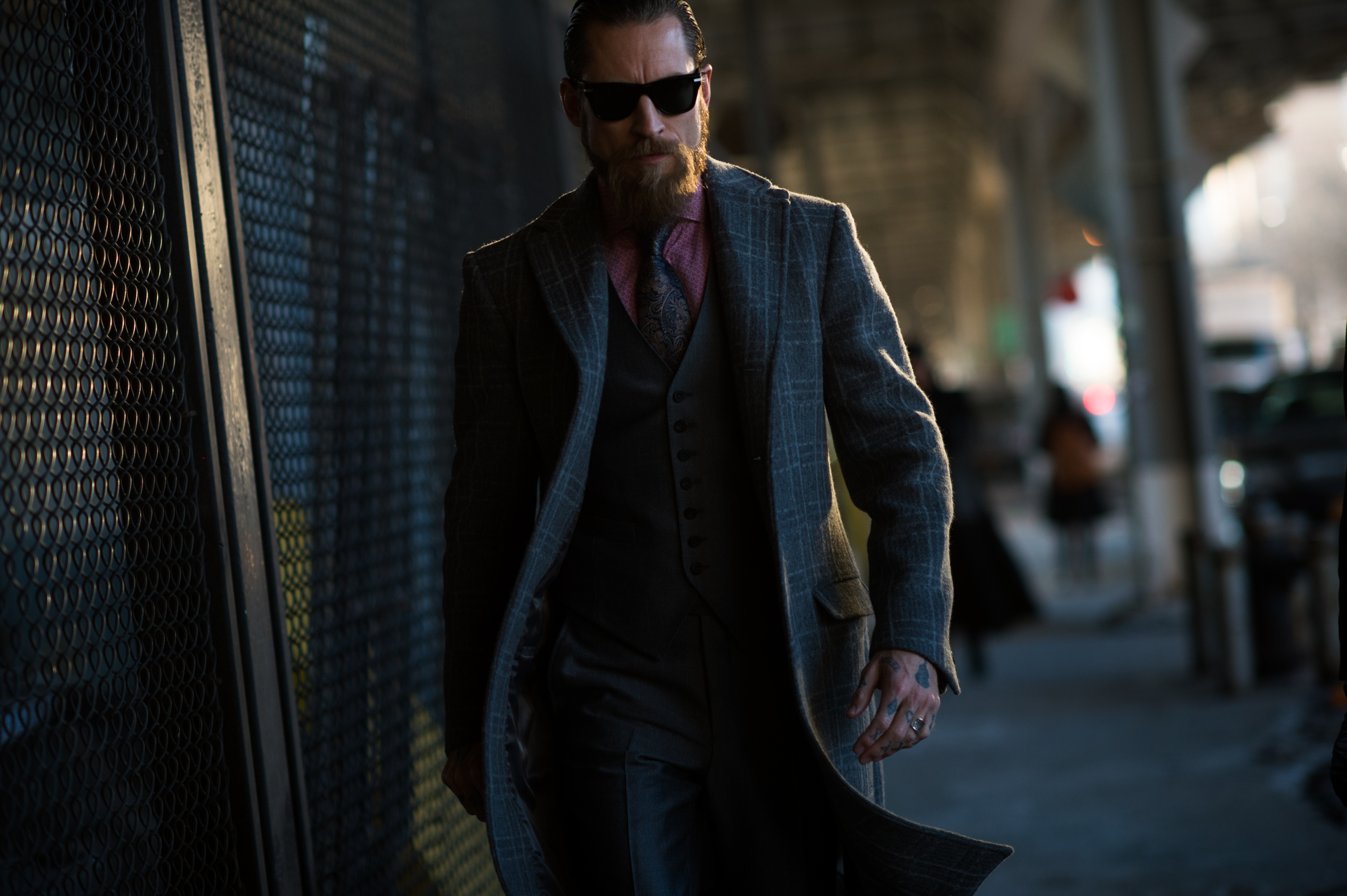 MyTheresa buyer wearing grey suit with sunglasses and tattoos