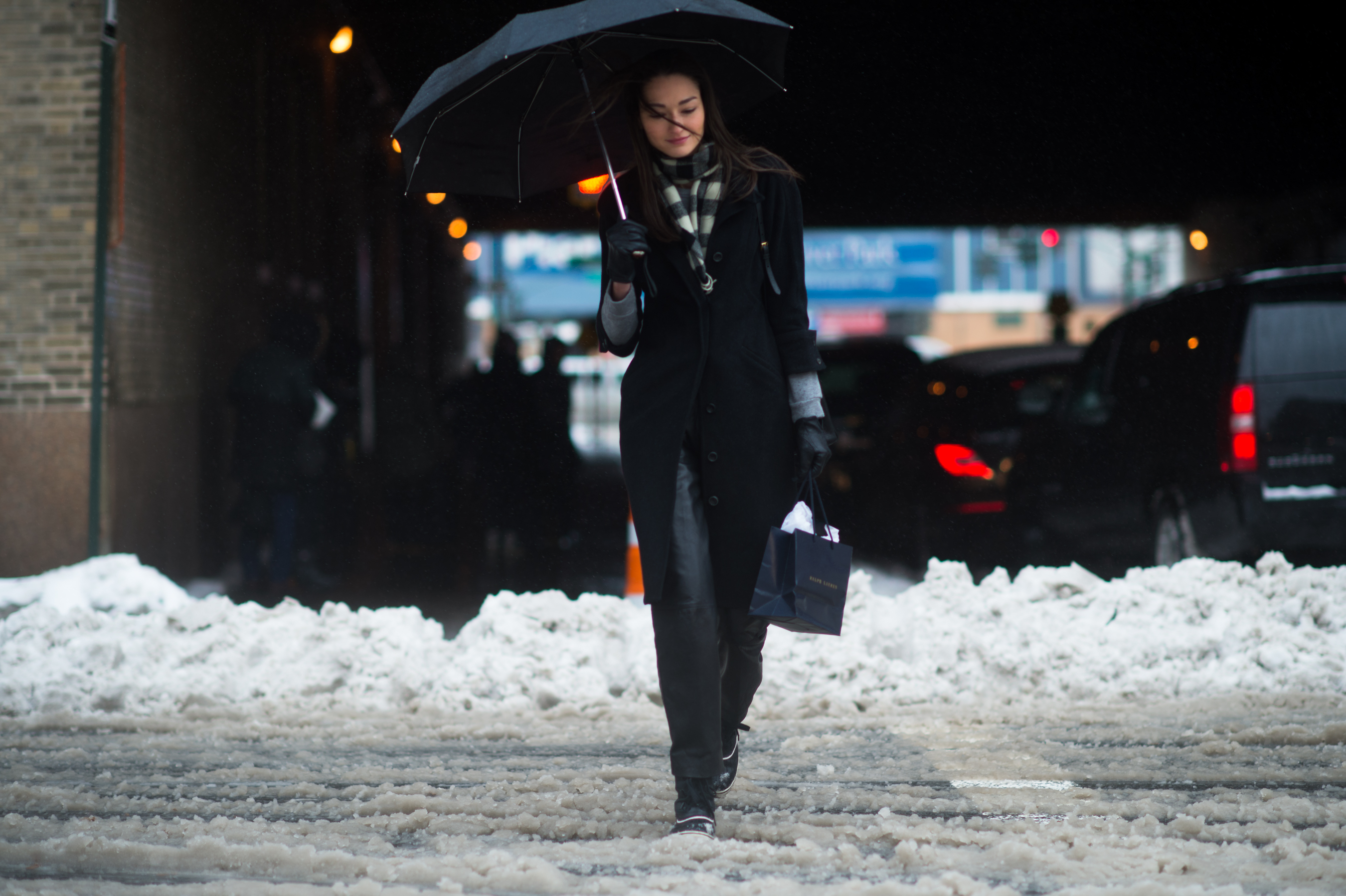 Brazilian model crossing the street in the snow
