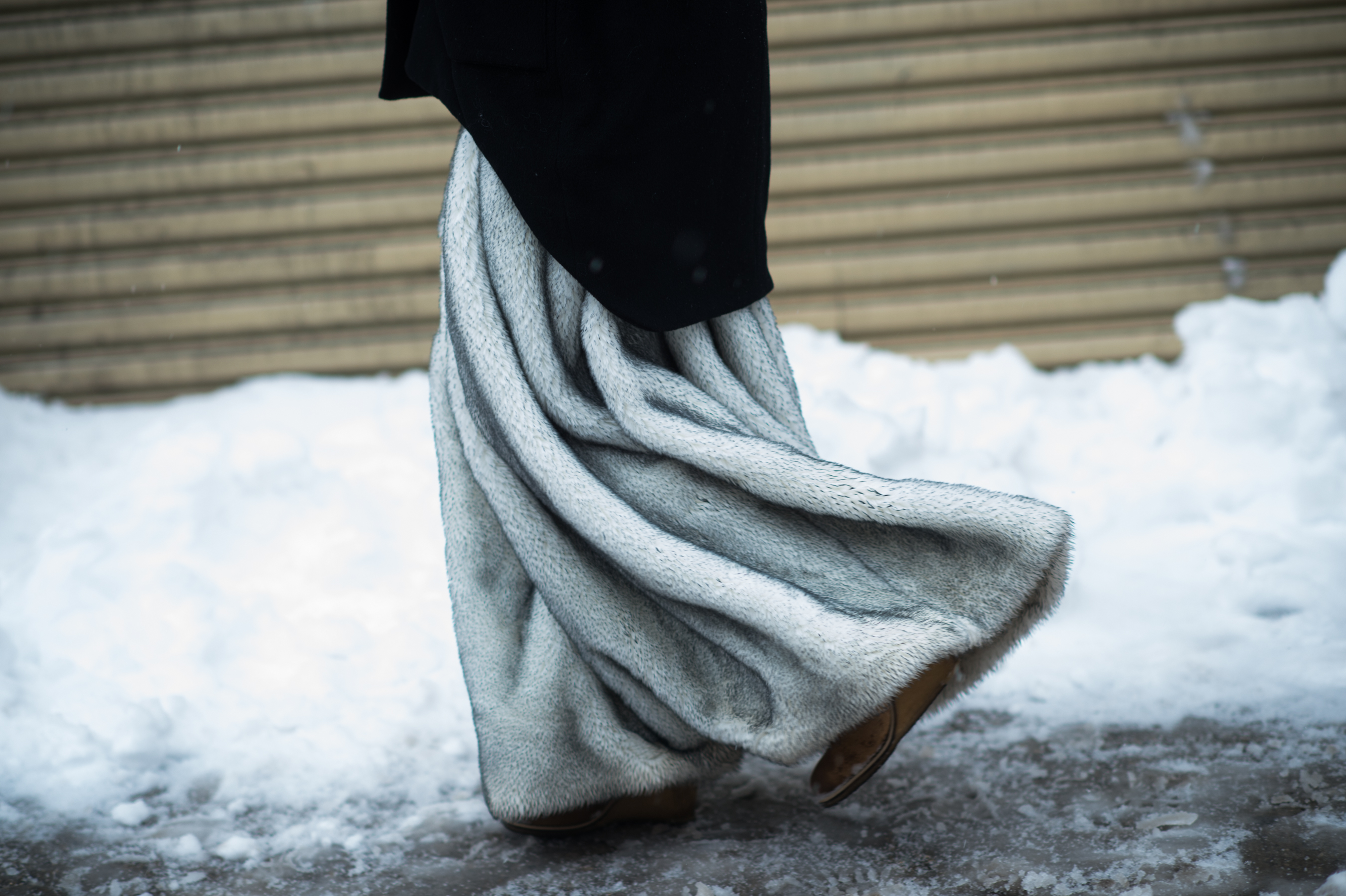 Woman wearing a fur skirt in the snow