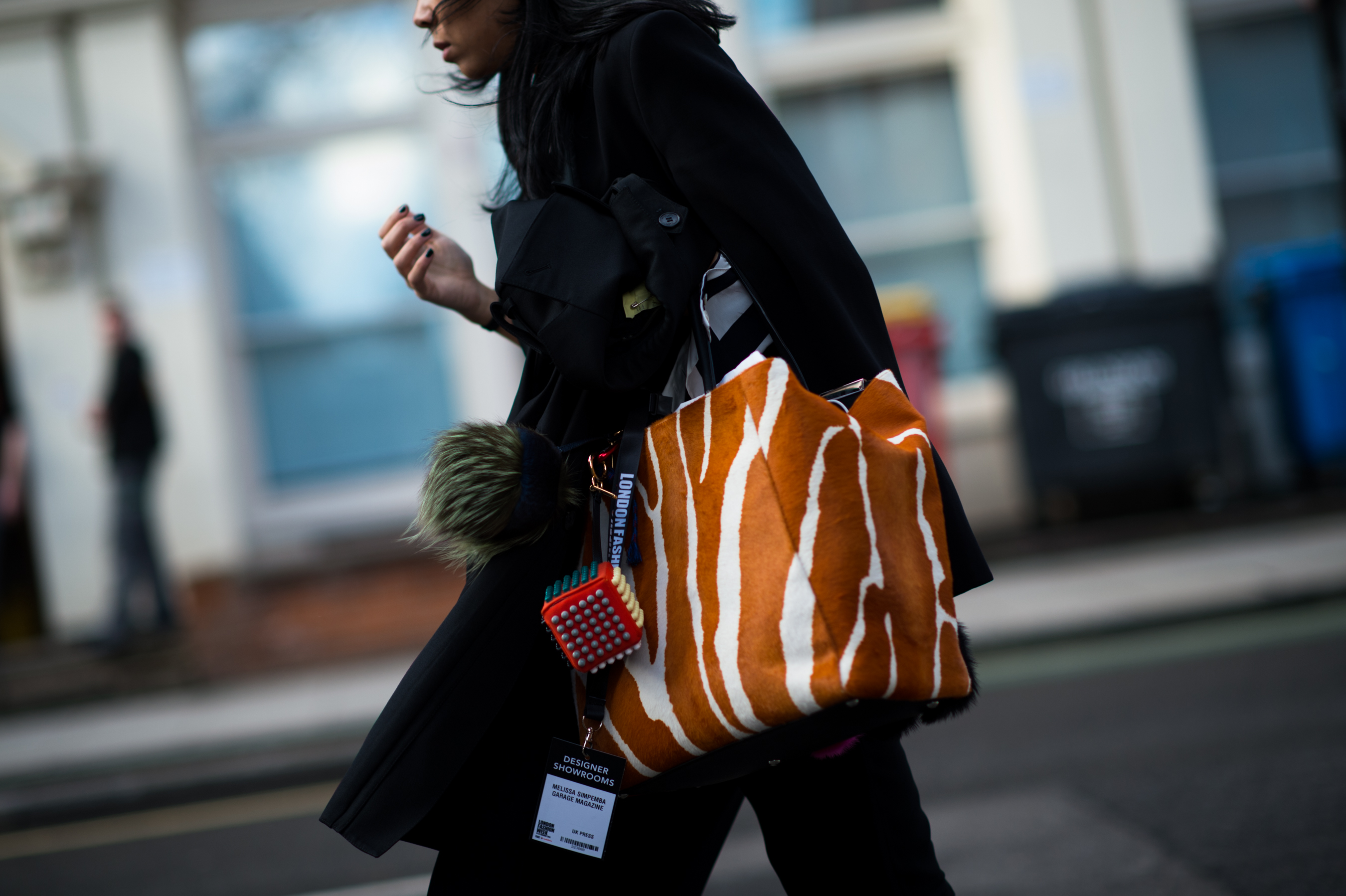 Woman with Giraffe bag and Fendi fur toy
