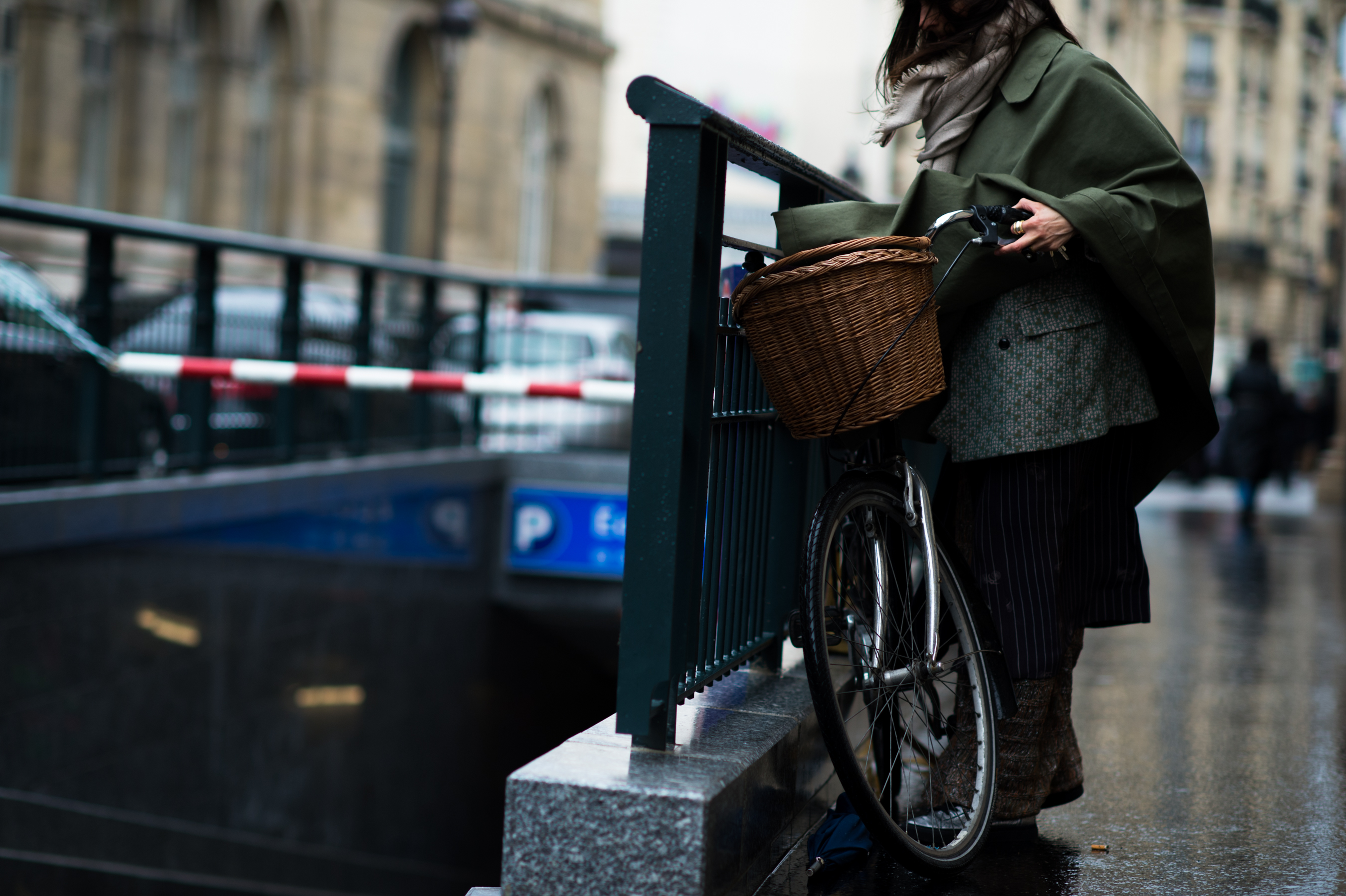 Woman locking her bicycle to a fence