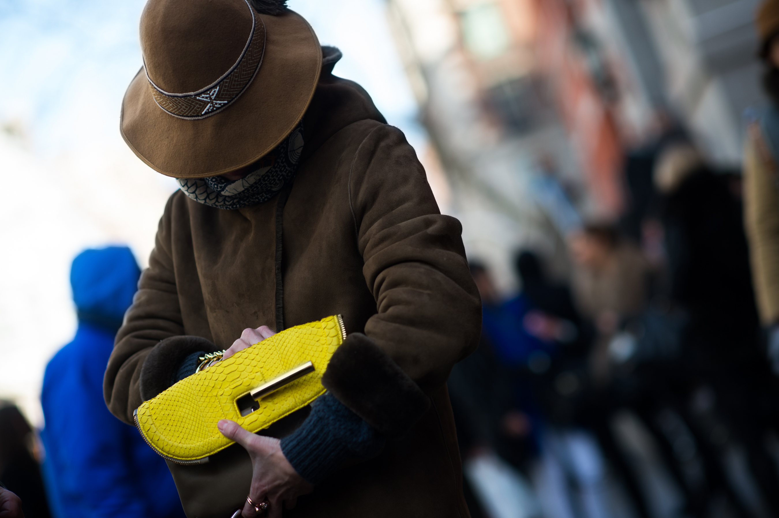 Woman wearing a brown hat looking in her bag