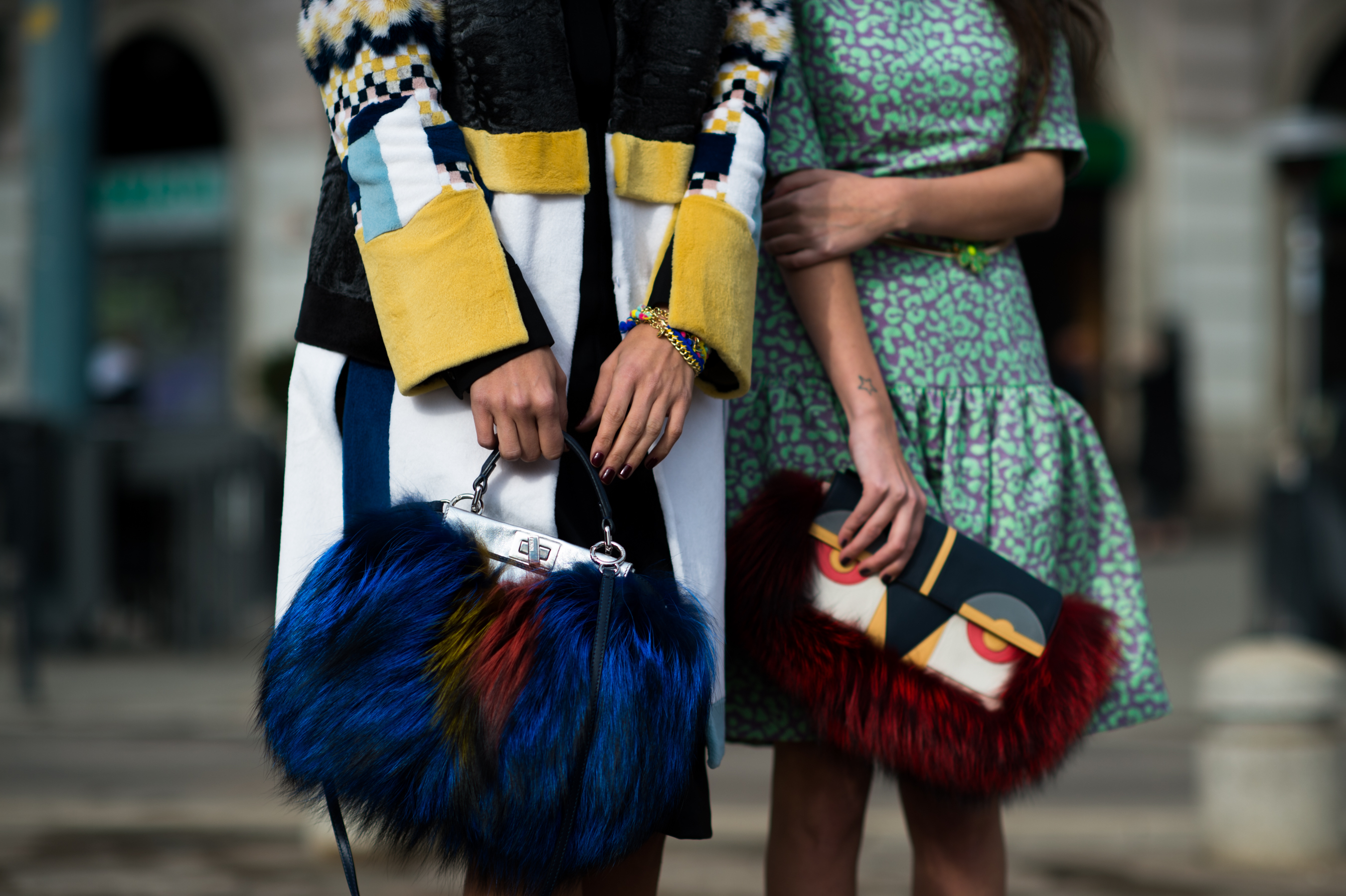 Two women with Fendi fur bags