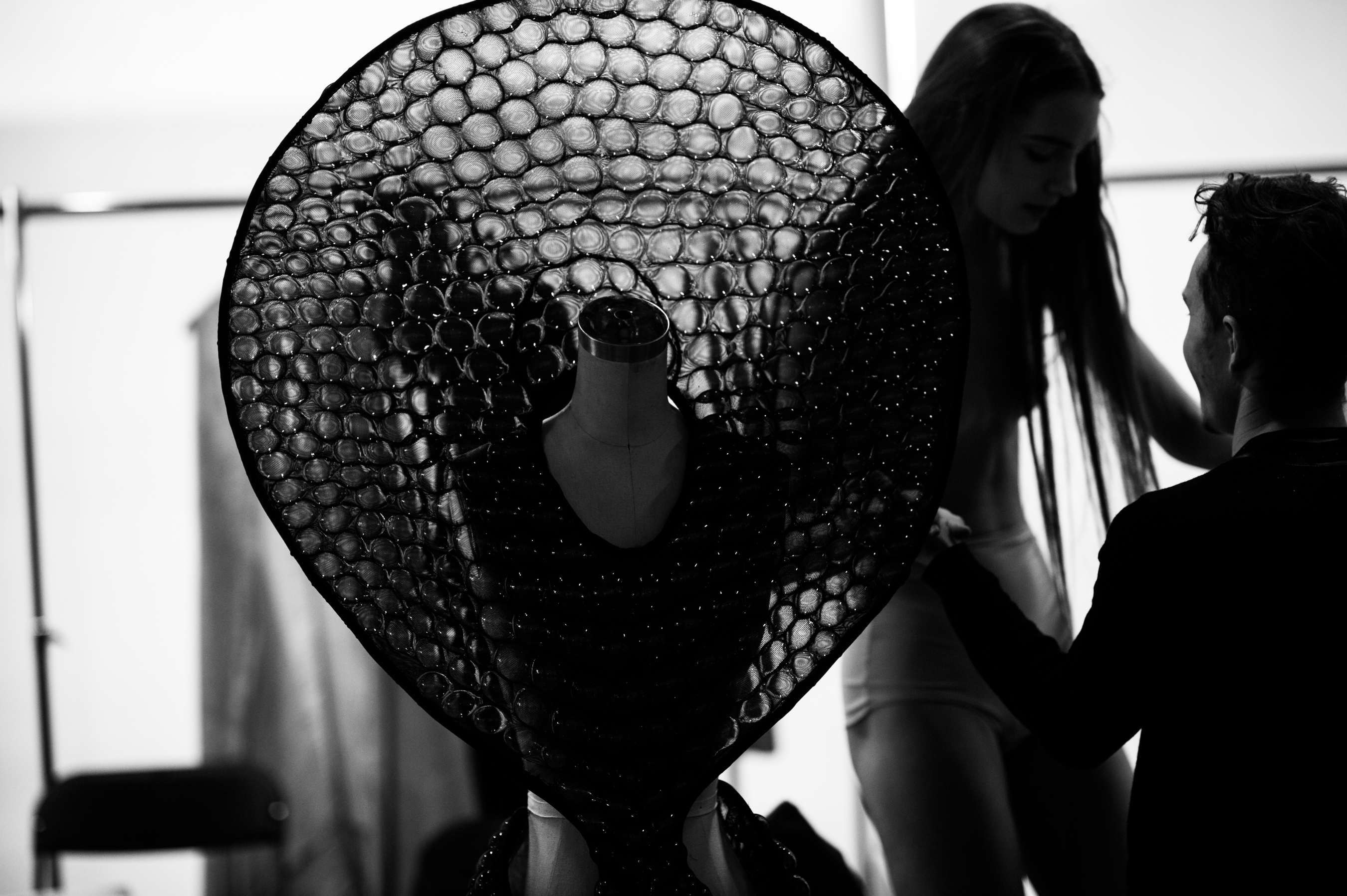 Model changing behind bubble dress
