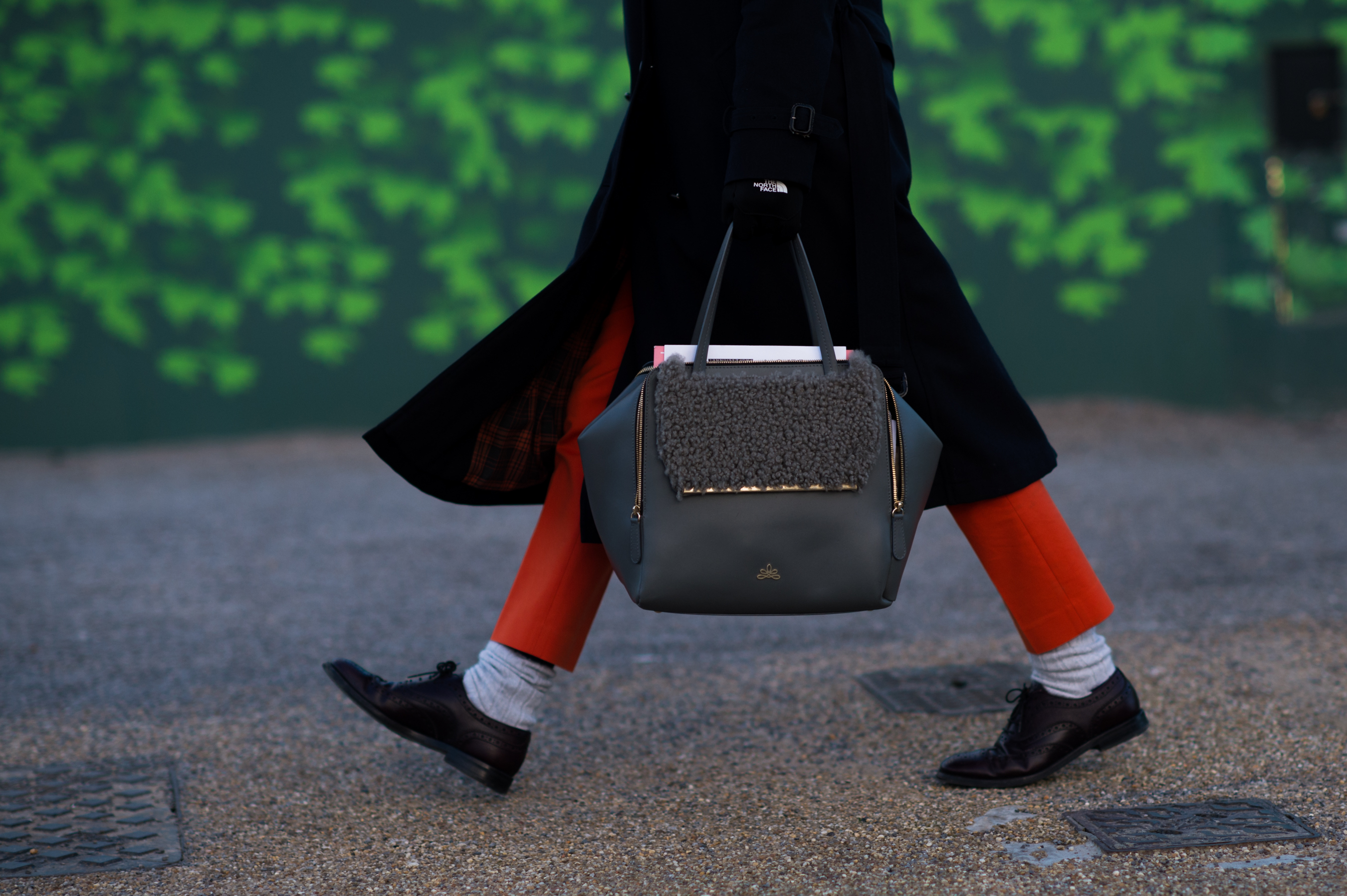 Woman carrying grey shearling bag