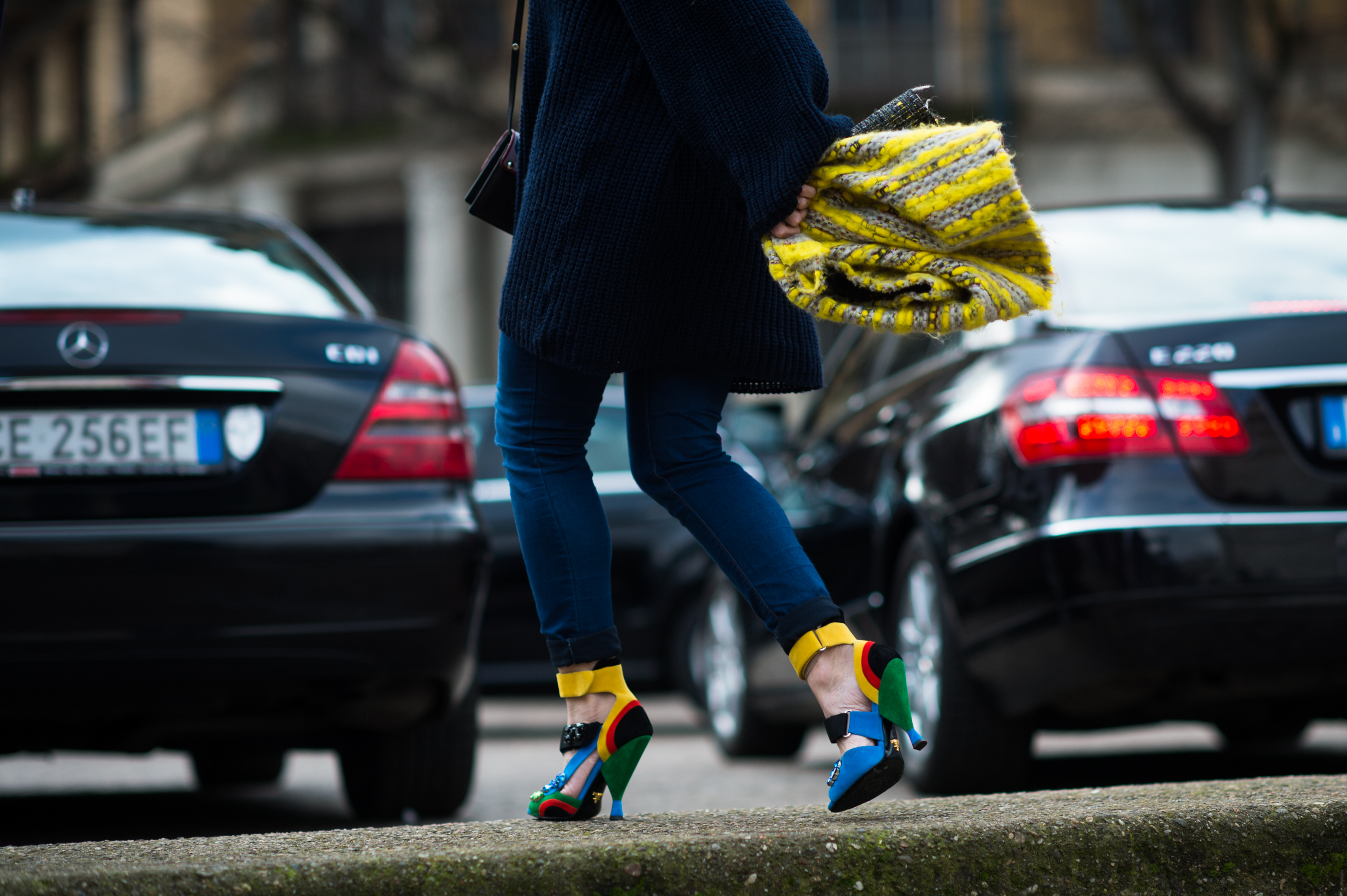 Woman wearing rainbow colour Prada shoes