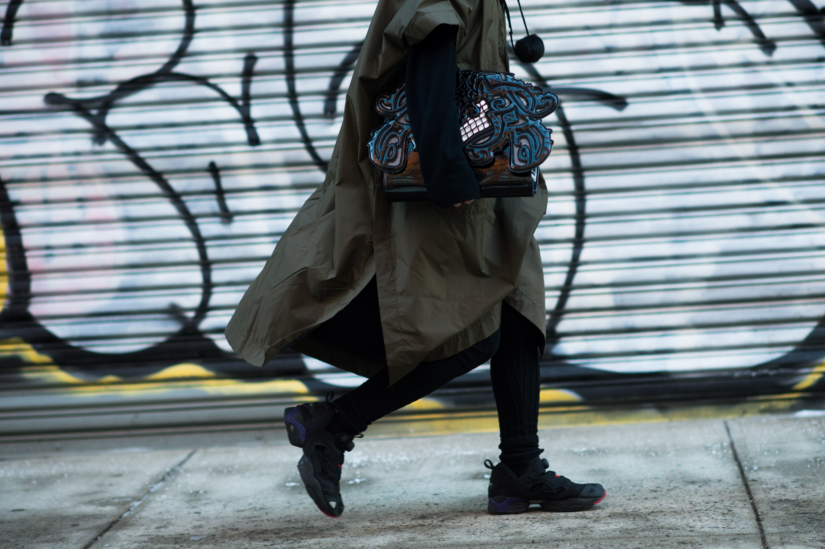 Woman carrying KTZ bag and Reebok pumps
