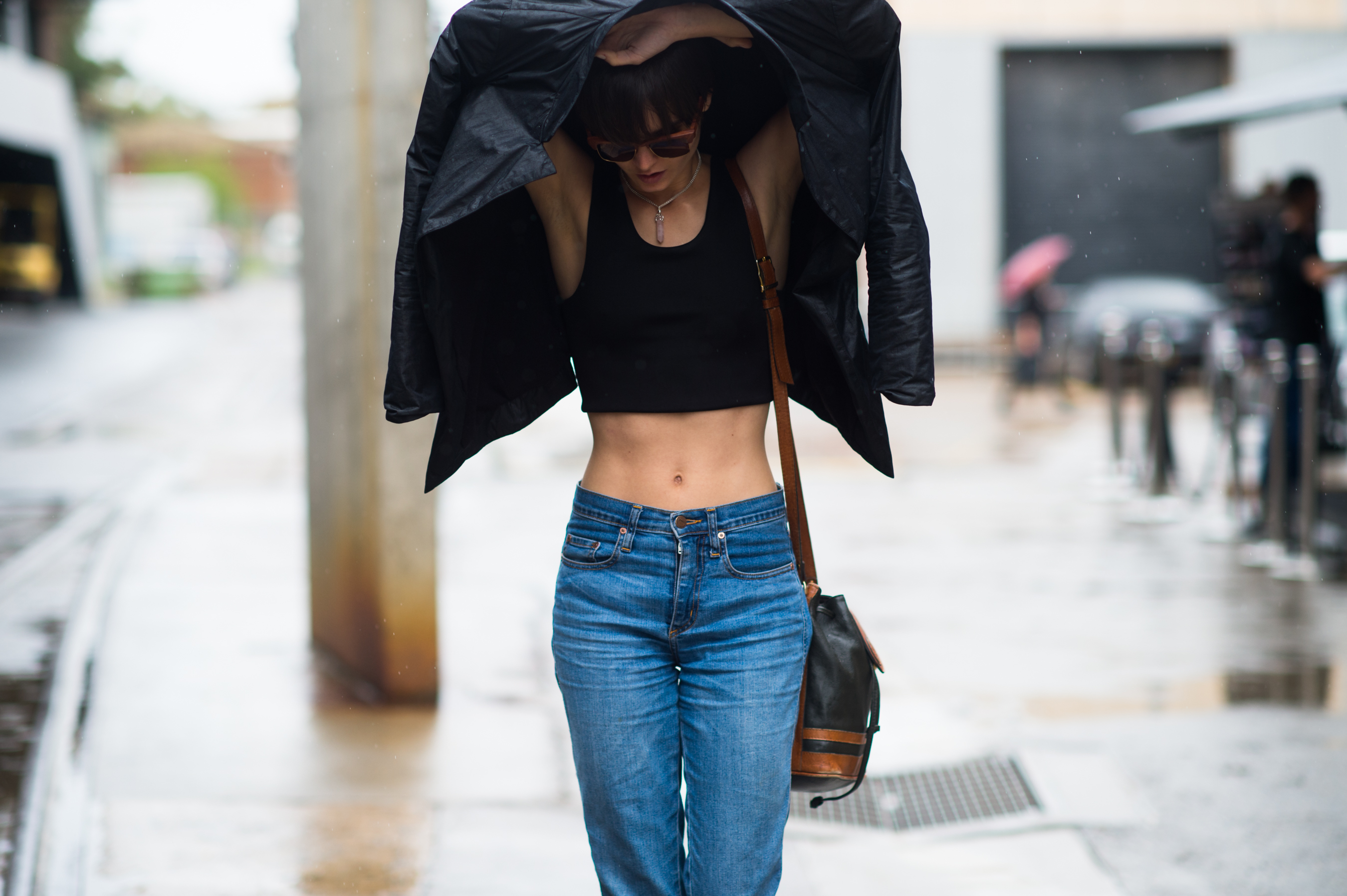 Skinny model with her jacket over her head