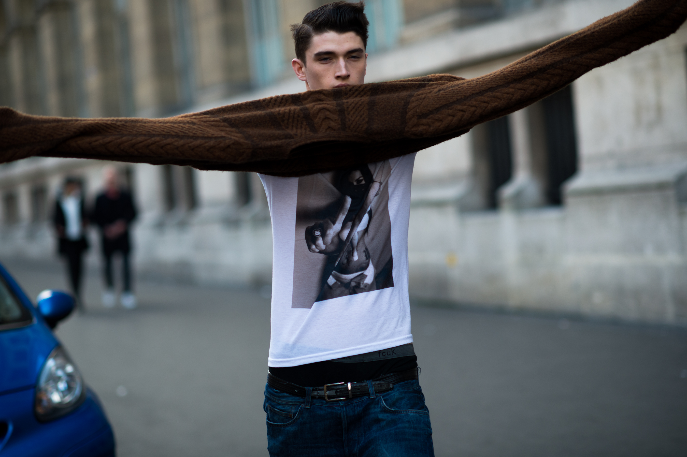 Male model putting on his sweater