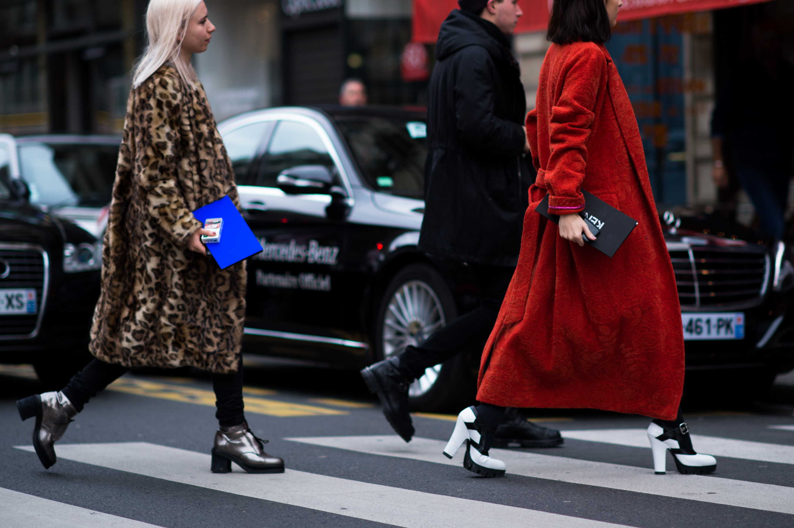 Three people crossing the street in France
