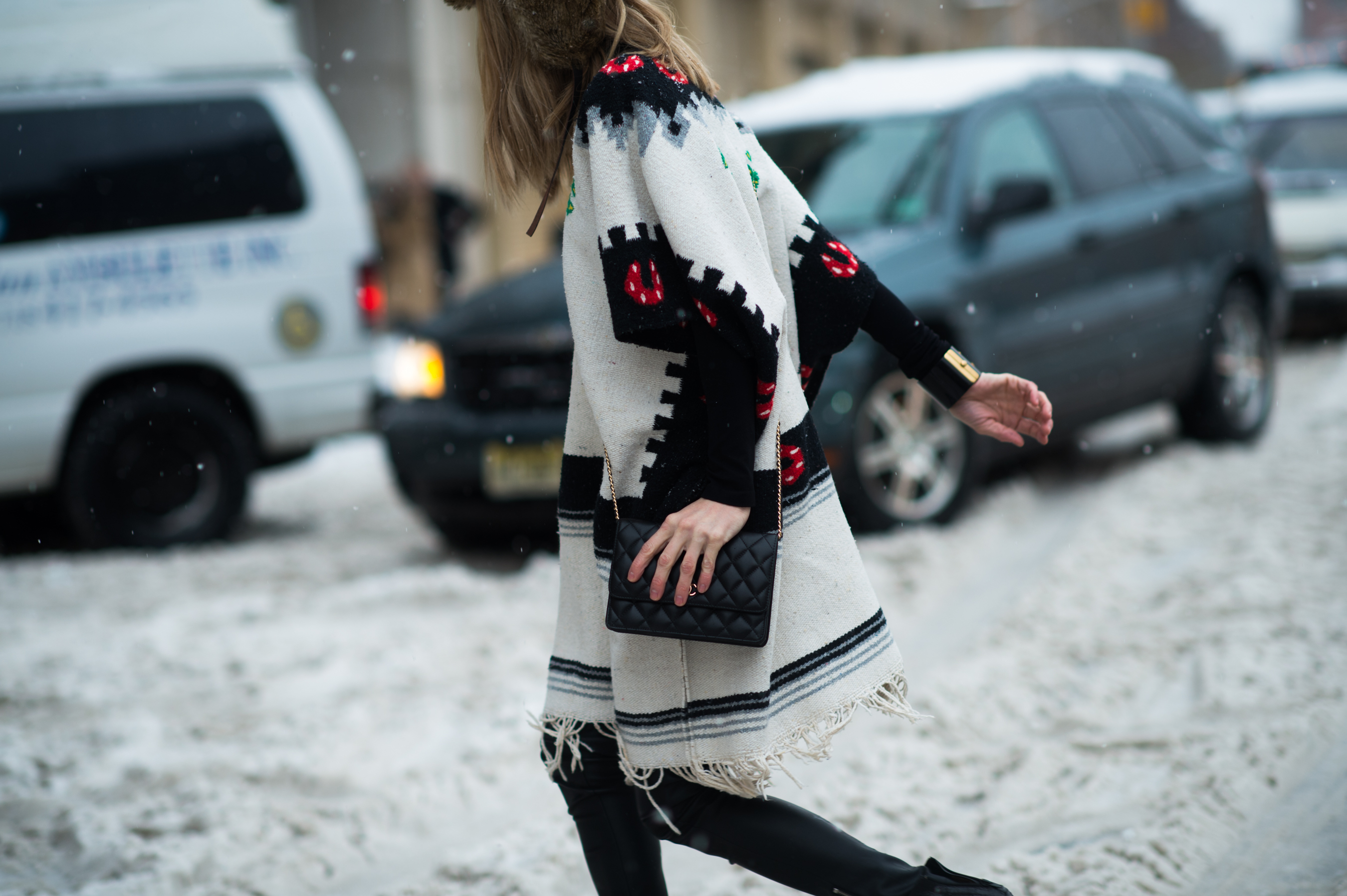 Woman wearing native cape in the snow
