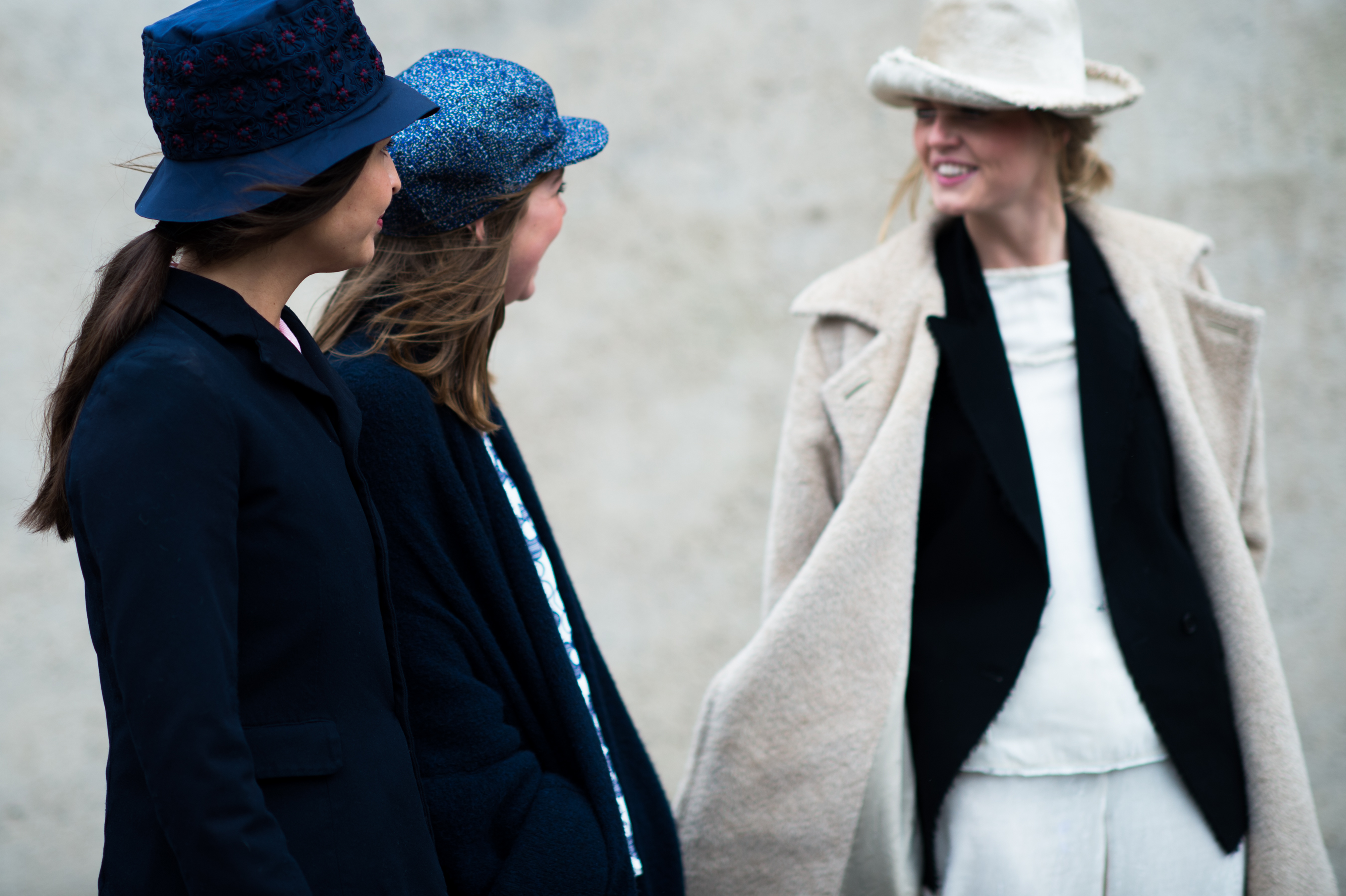 Three girls wearing hats