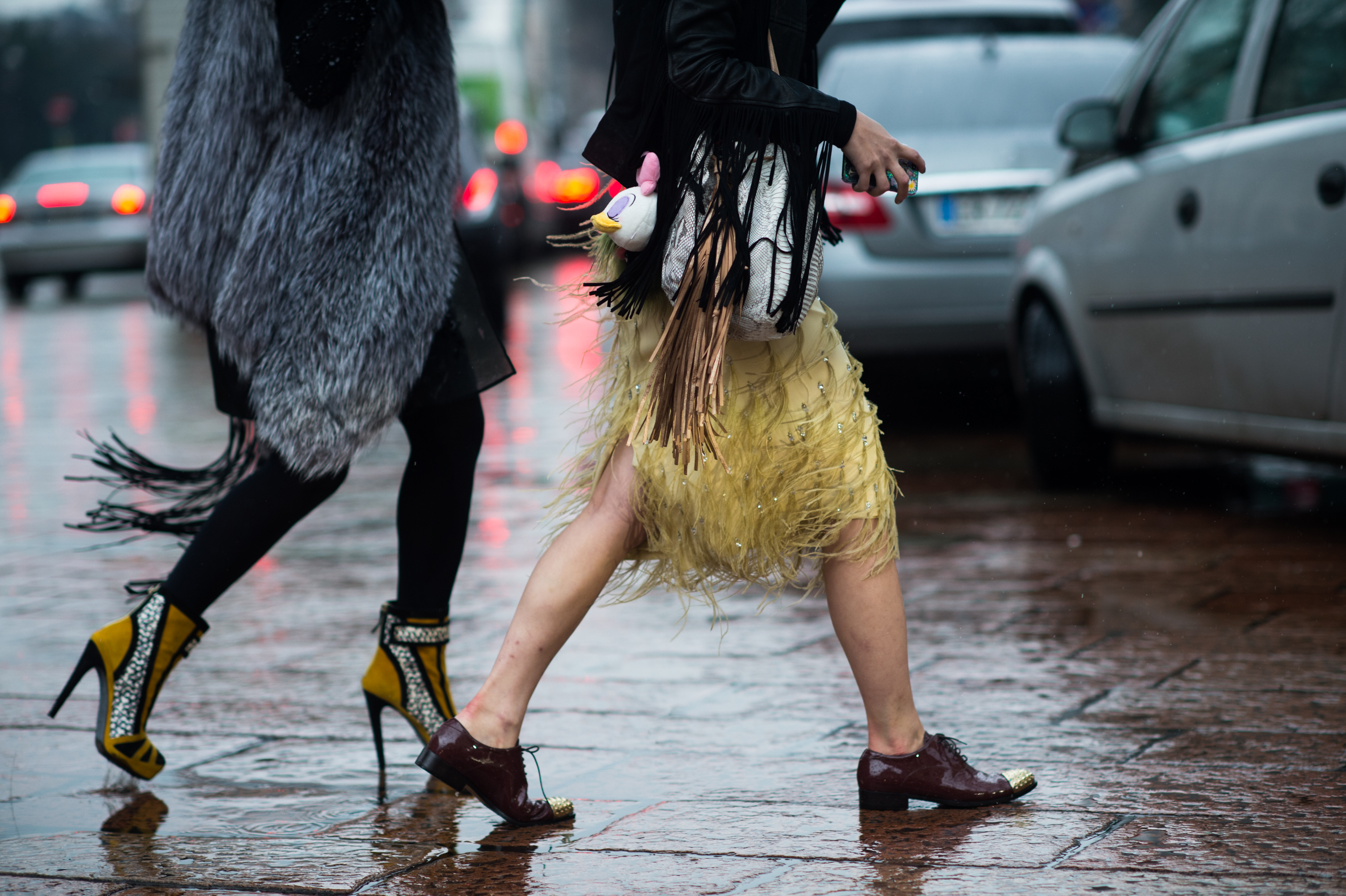 Two women with fringe walking in the rain