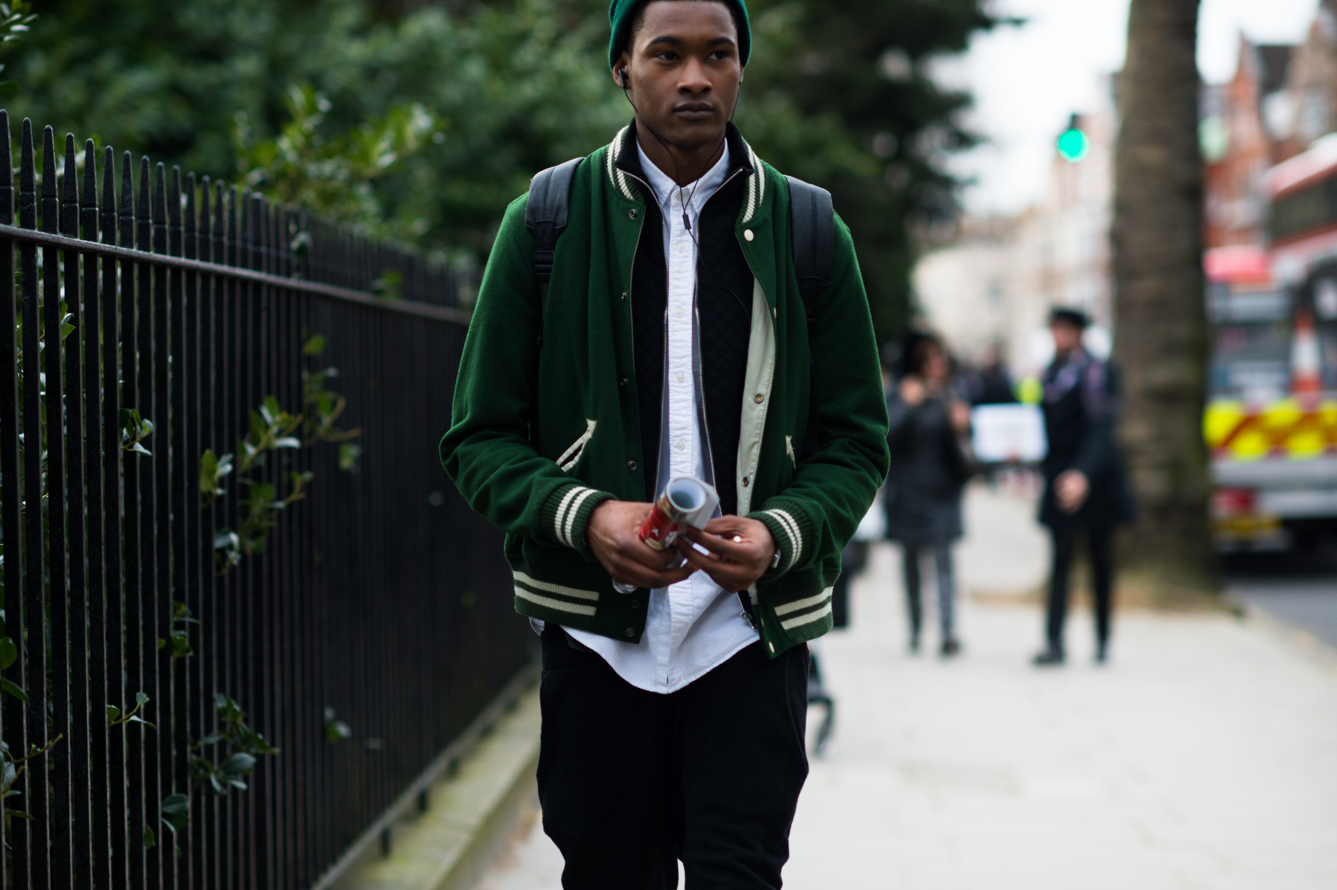 Male model wearing green varsity jacket