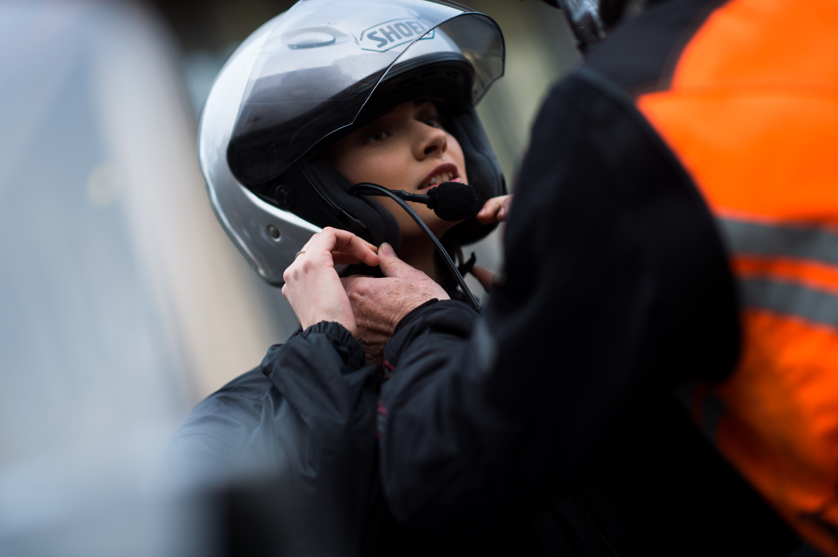 Model putting on her motorcycle helmet