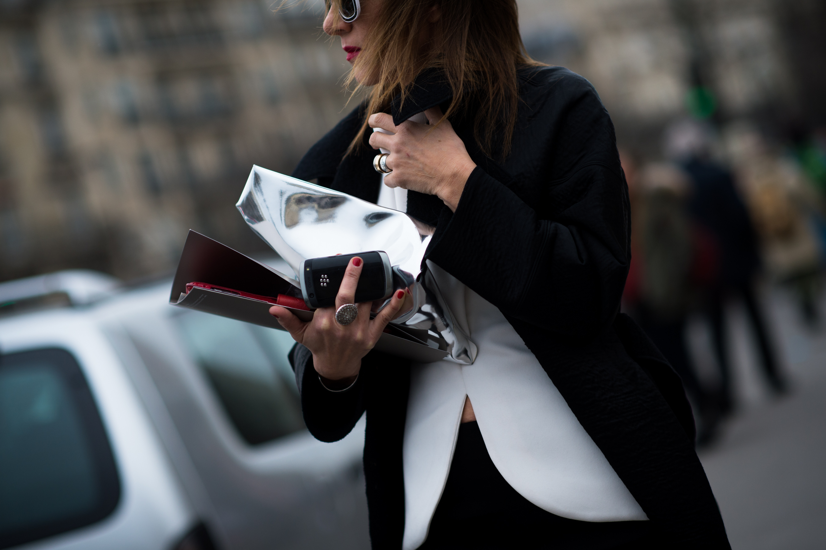 Woman holding her phone after couture show
