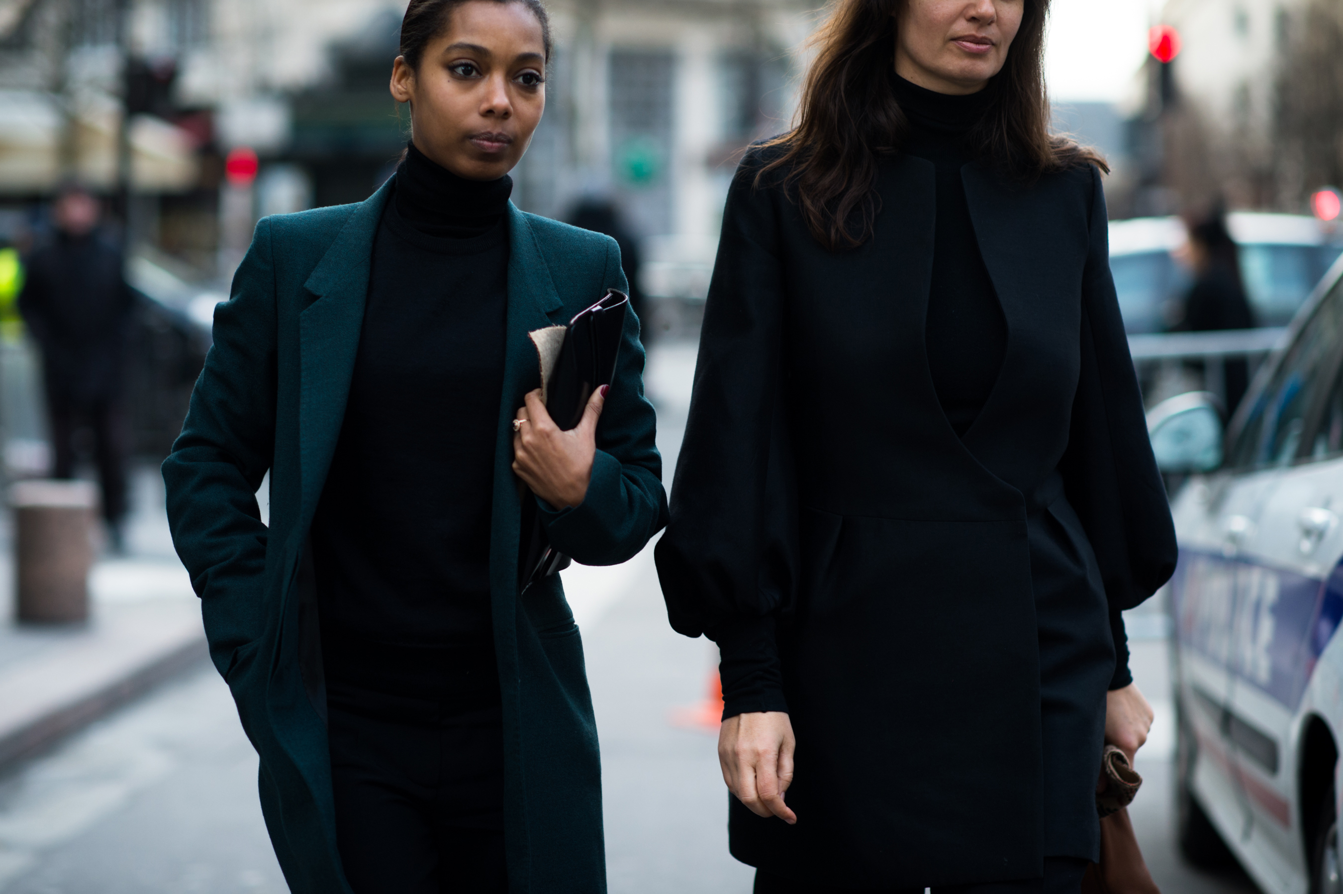 Two women wearing dark green jackets
