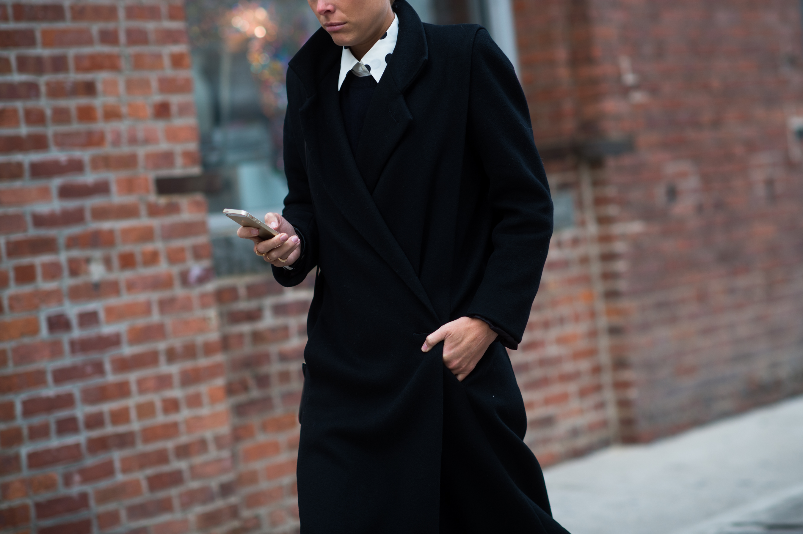Blonde woman wearing a black coat