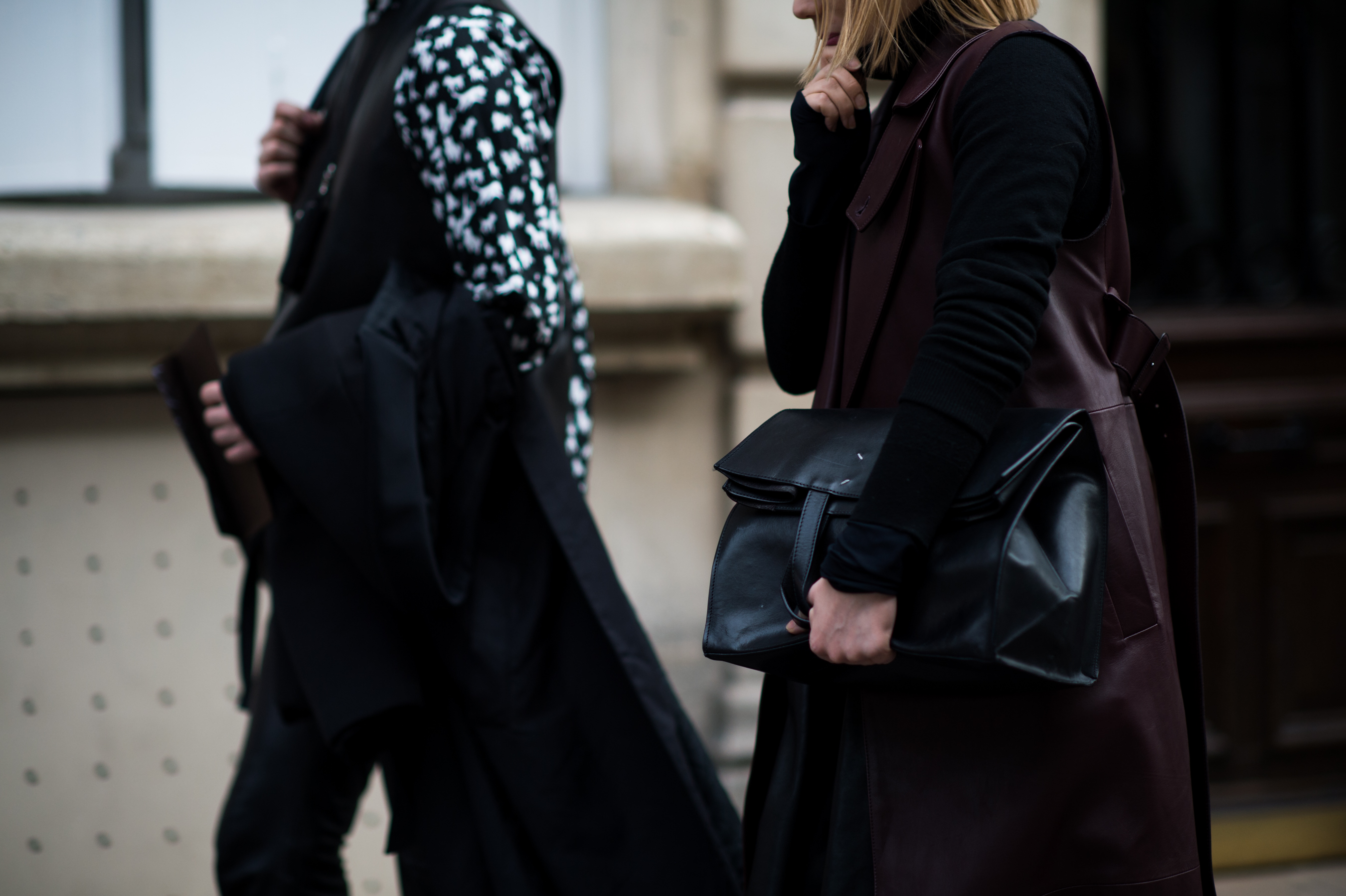 Woman wearing oxblood with a Margiela bag