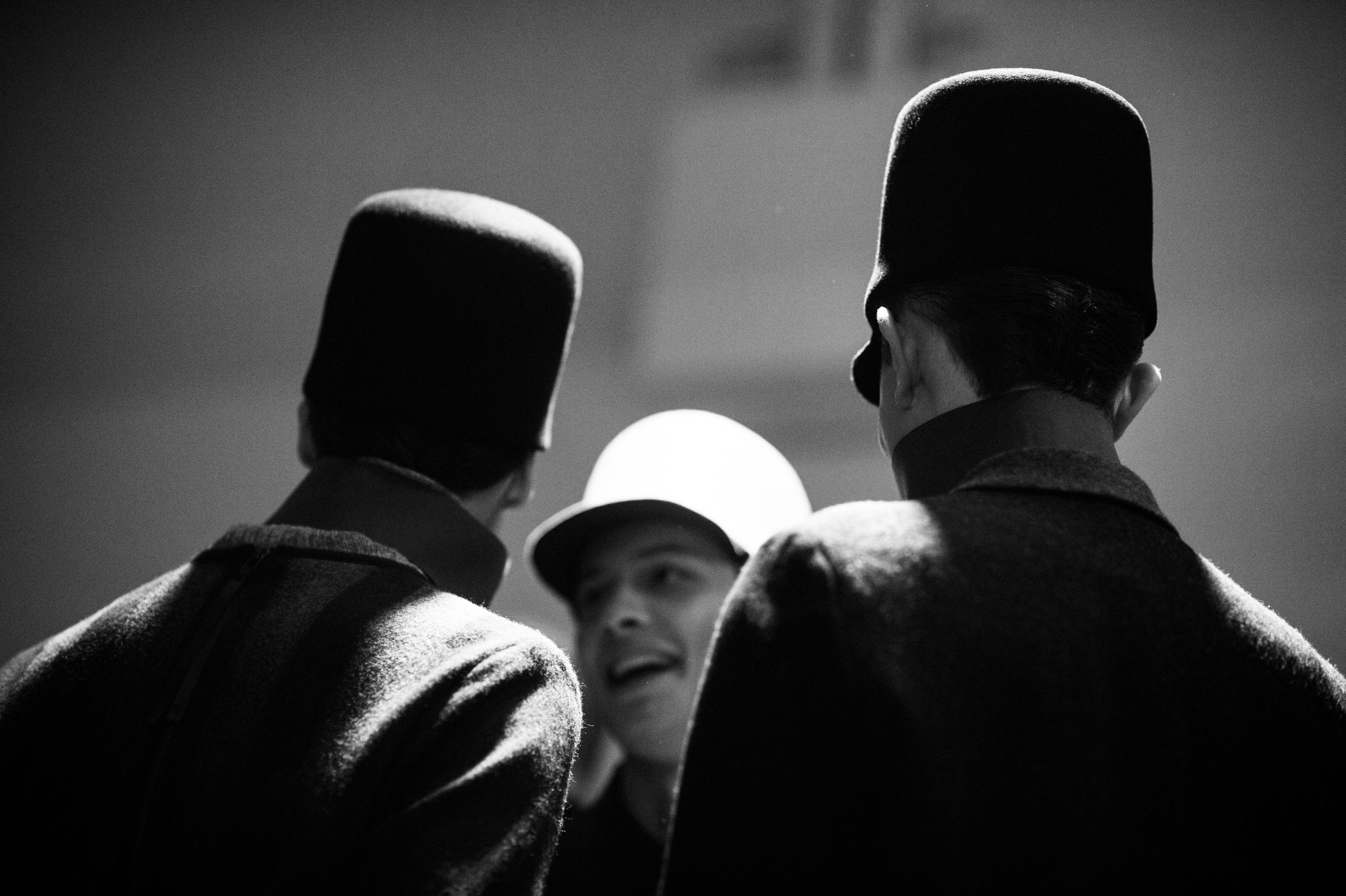 Male models wearing tall hats