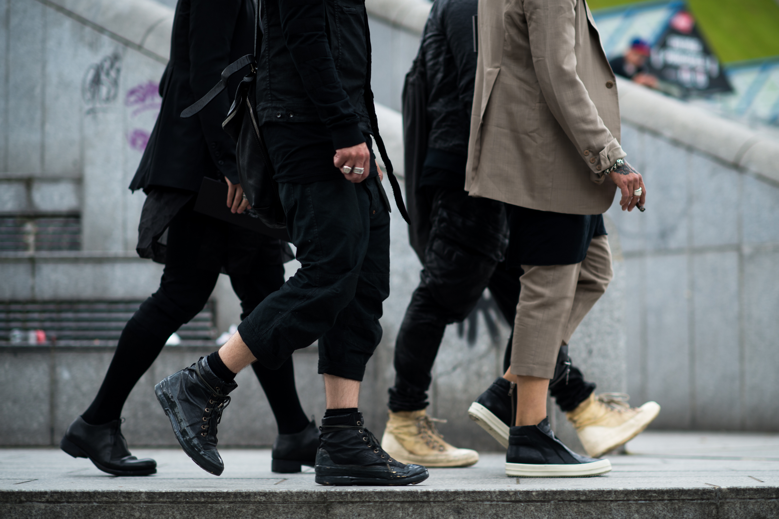 Four men wearing walking together