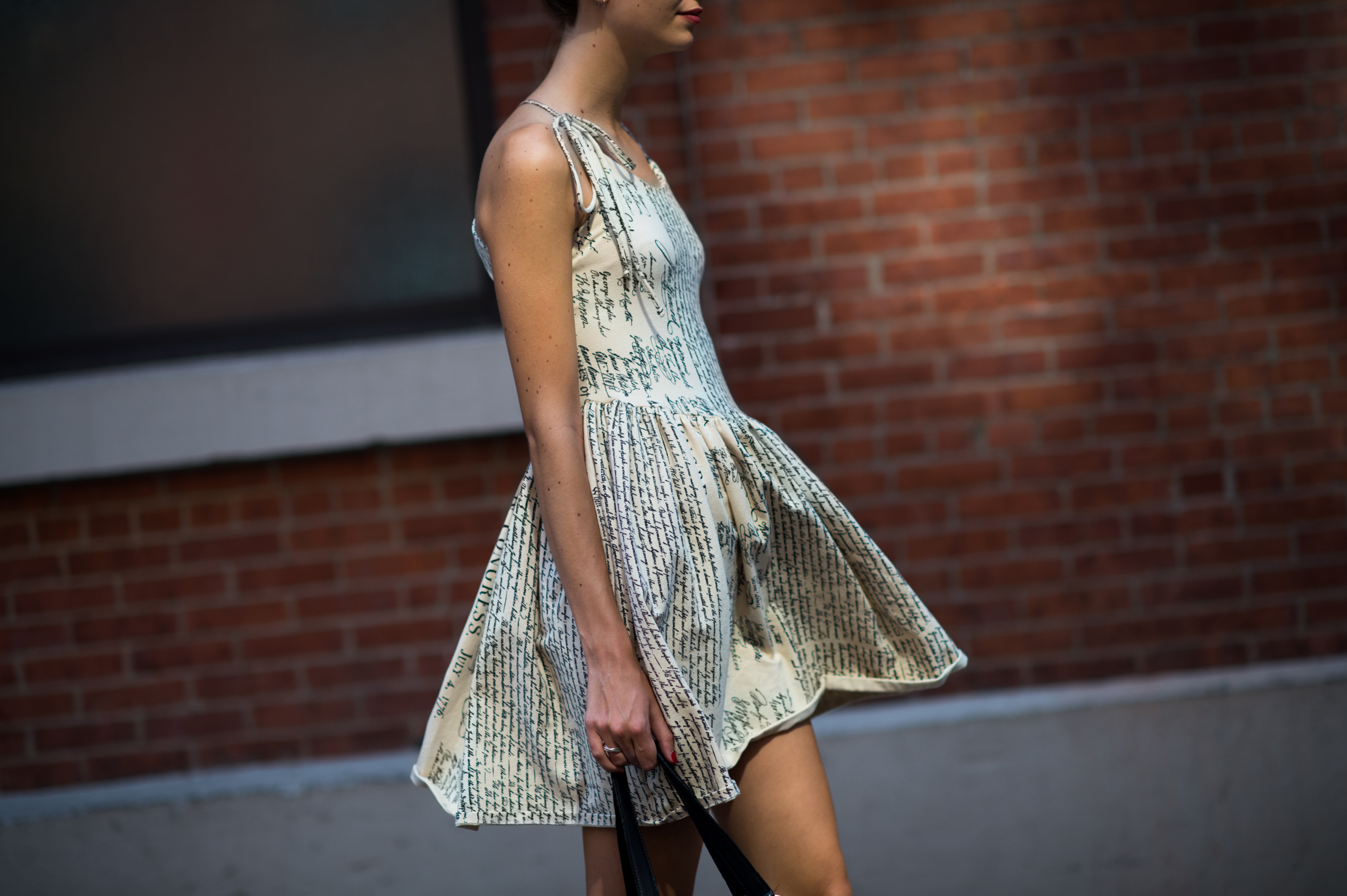 Woman wearing newsprint dress