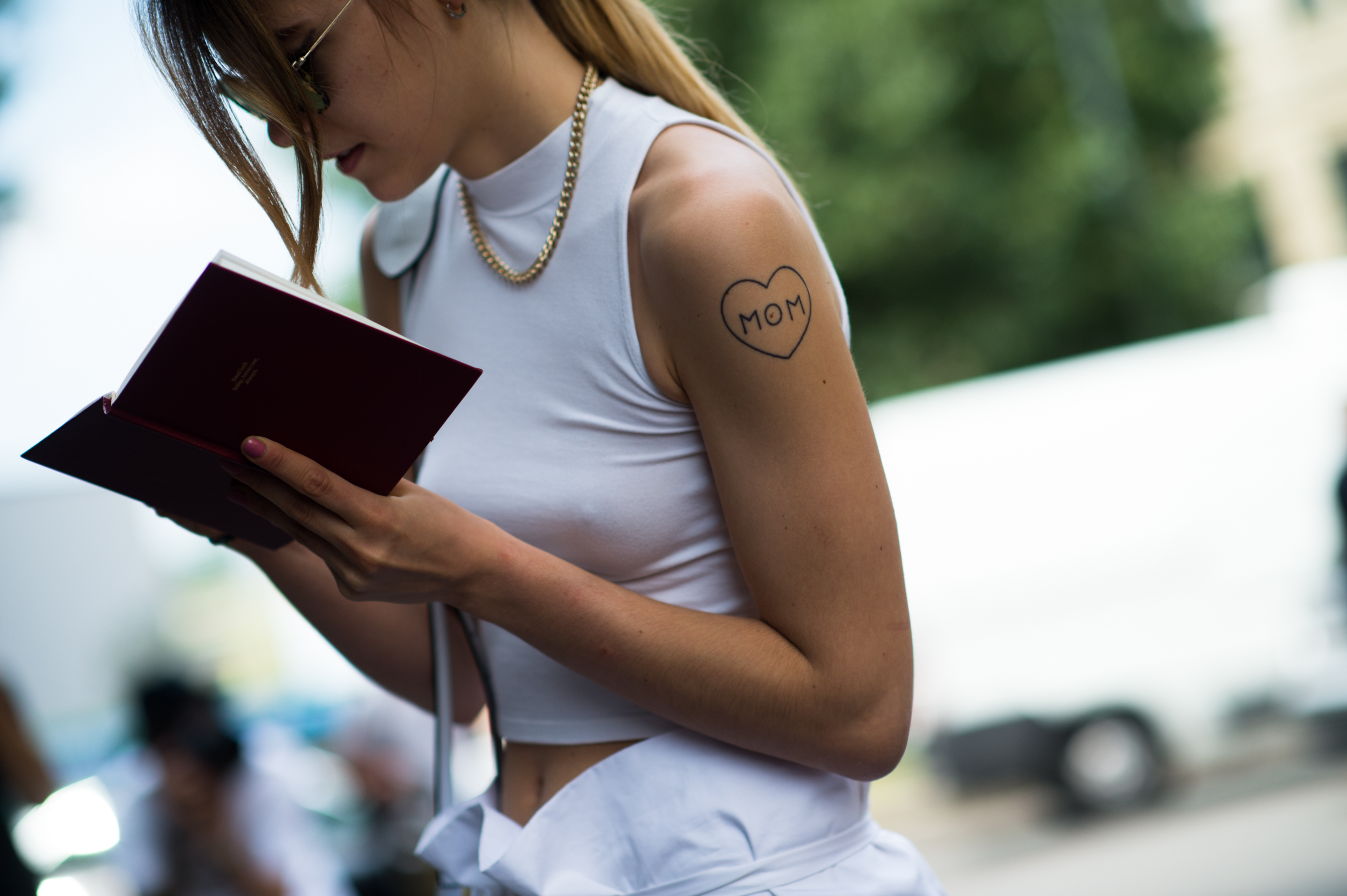 Sicilian girl wearing all white with MOM tattoo