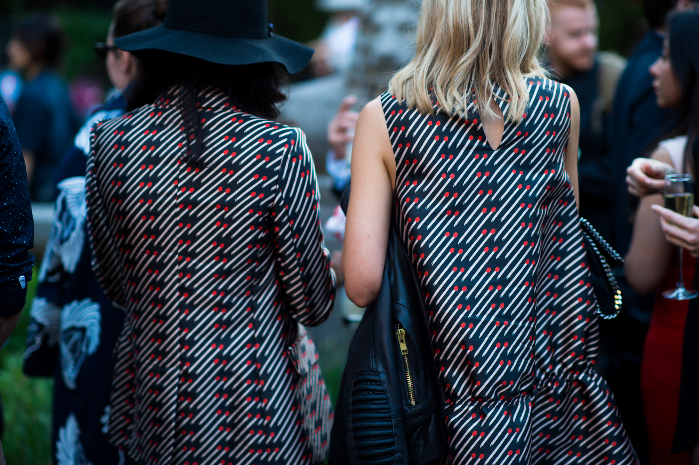 Two women wearing matching printed suits