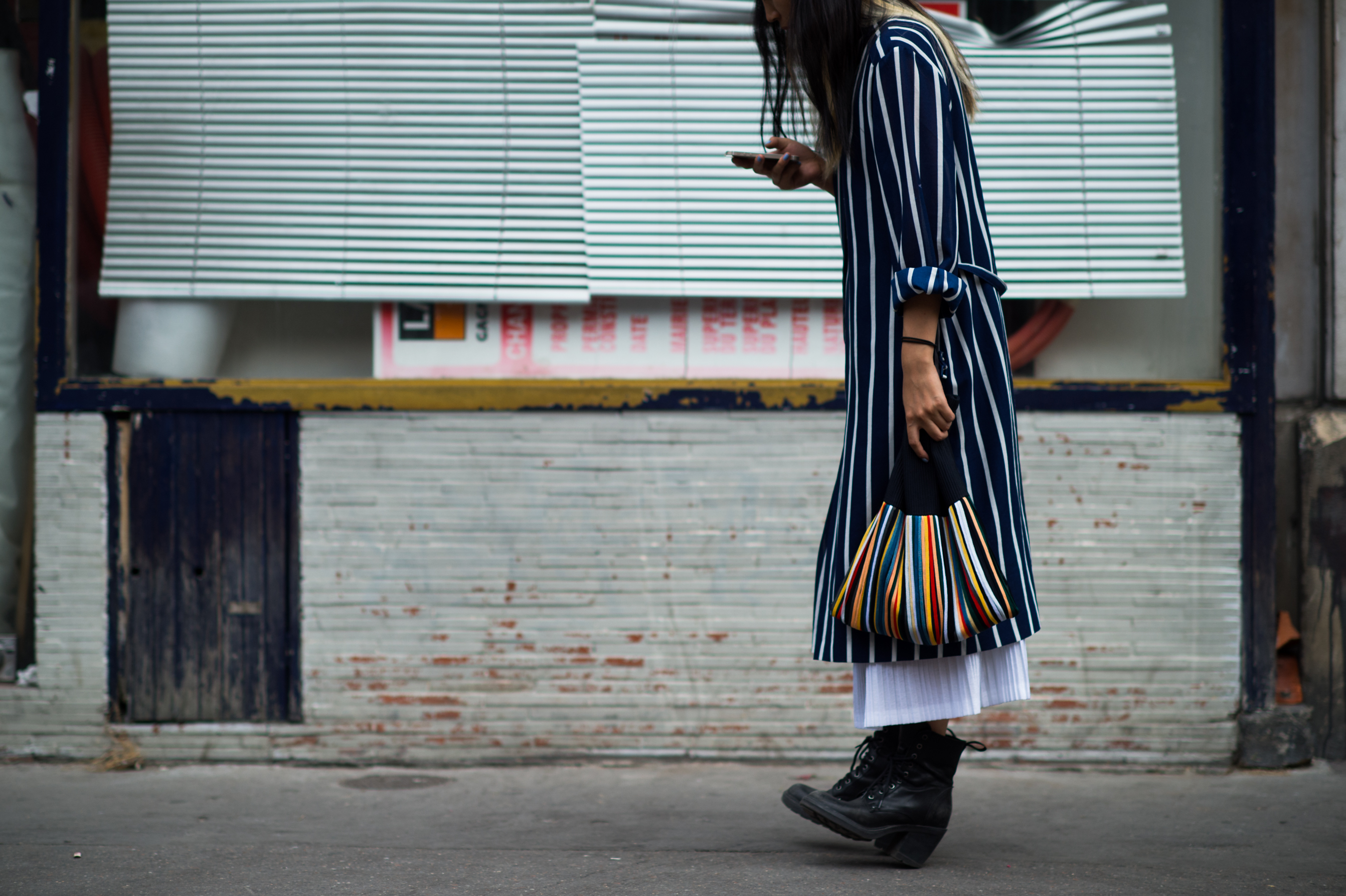 Girl wearing striped jacket and bag