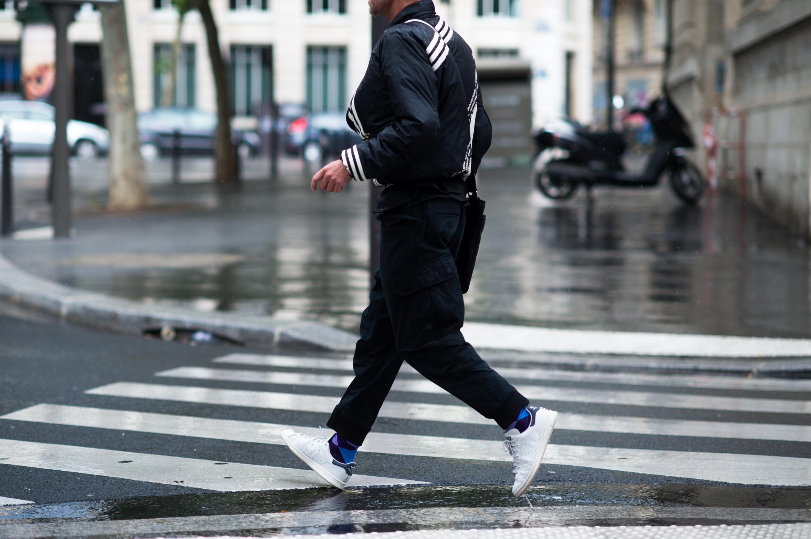 Man wearing Adidas striped jacket