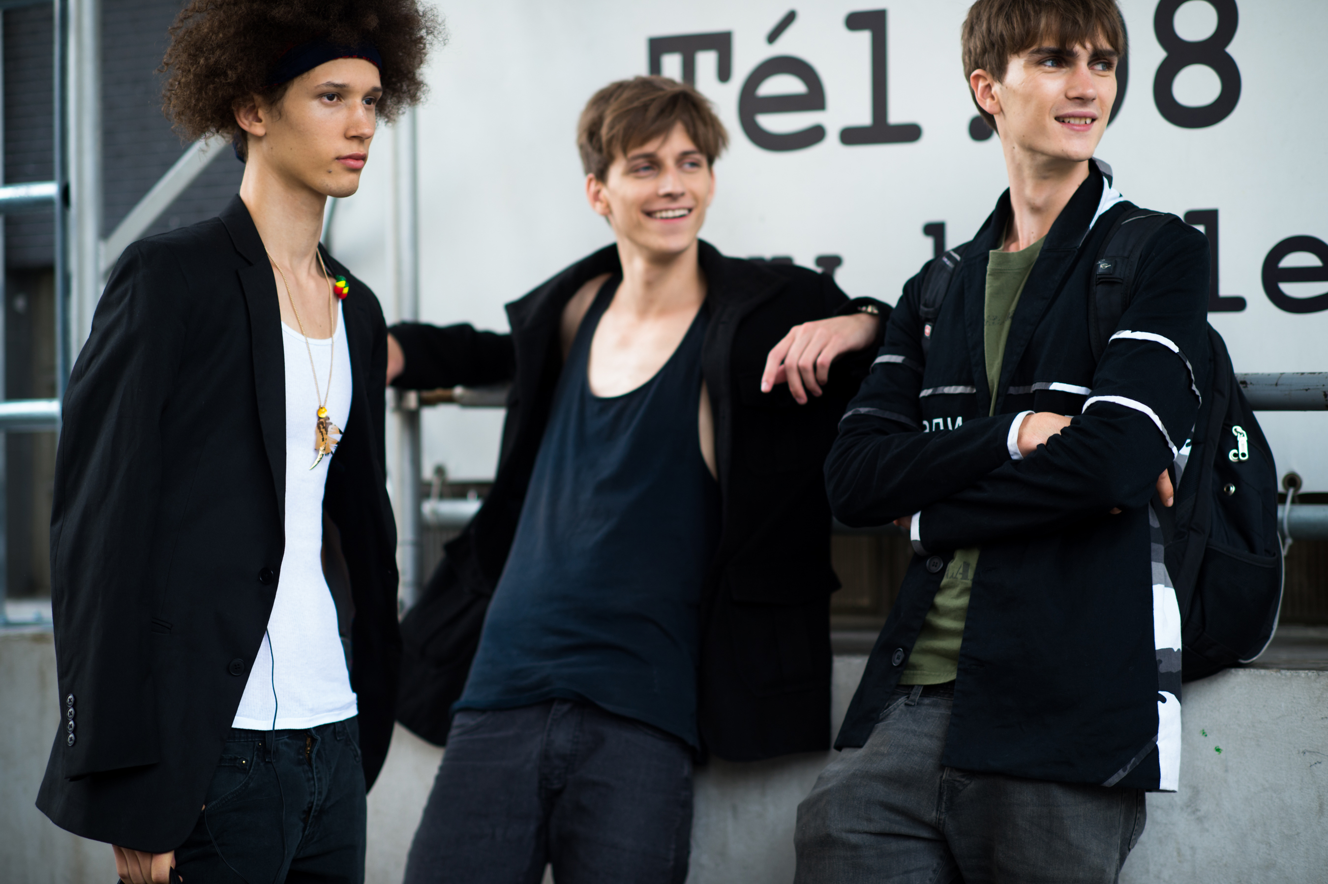 Three male models after a fashion show