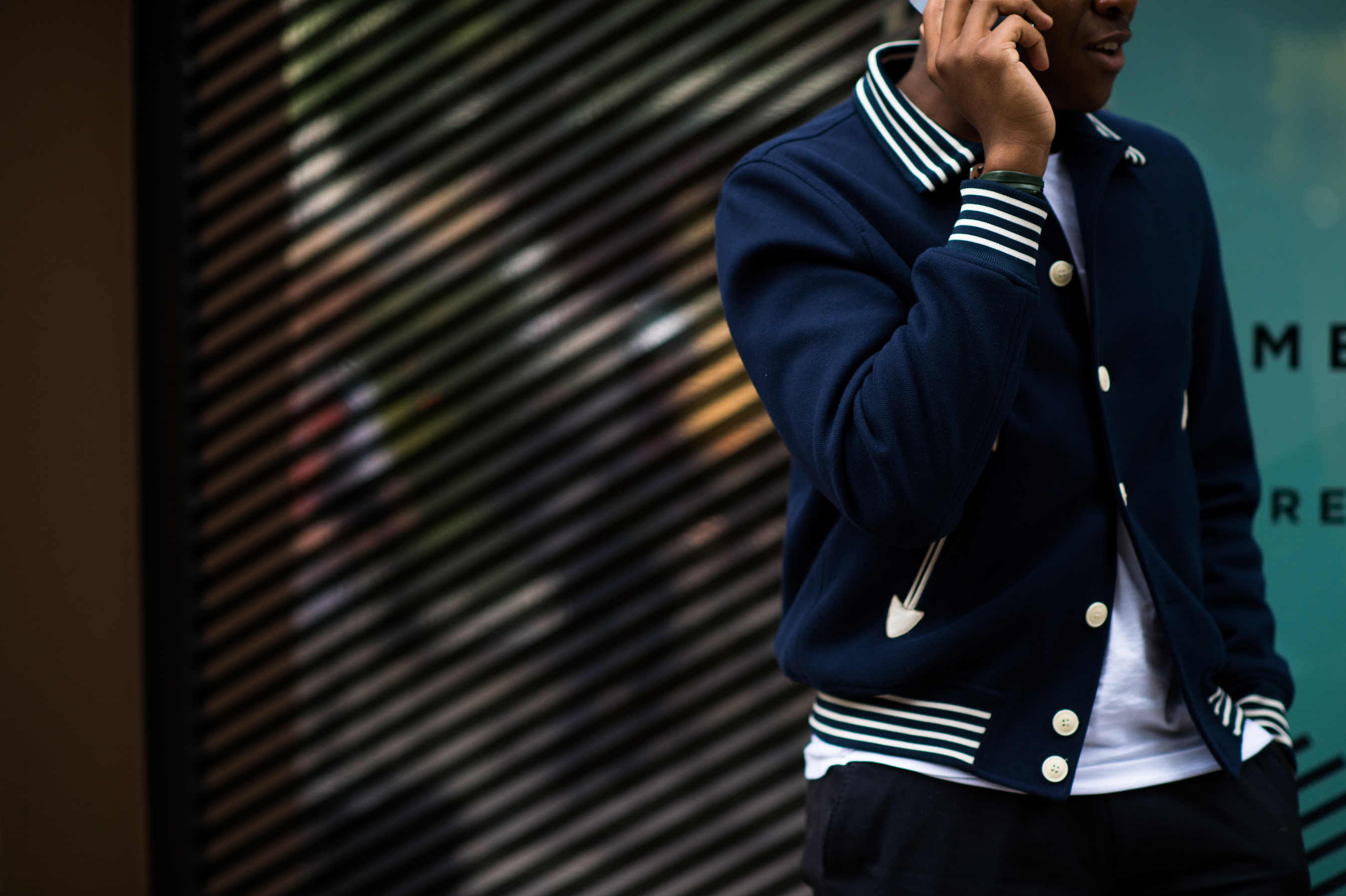 Man wearing varsity striped jacket