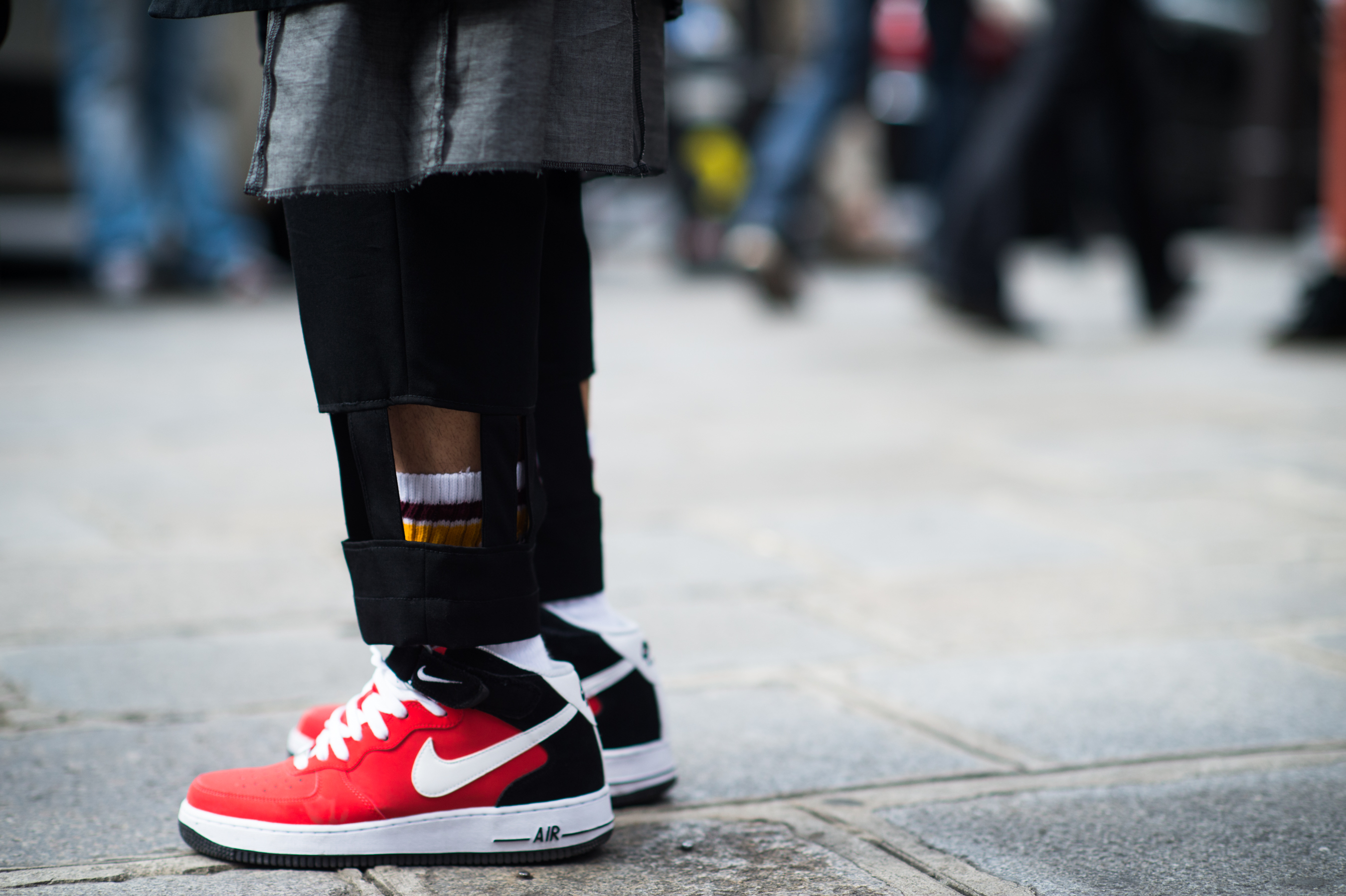 Man wearing Nike sneakers and cut out pants
