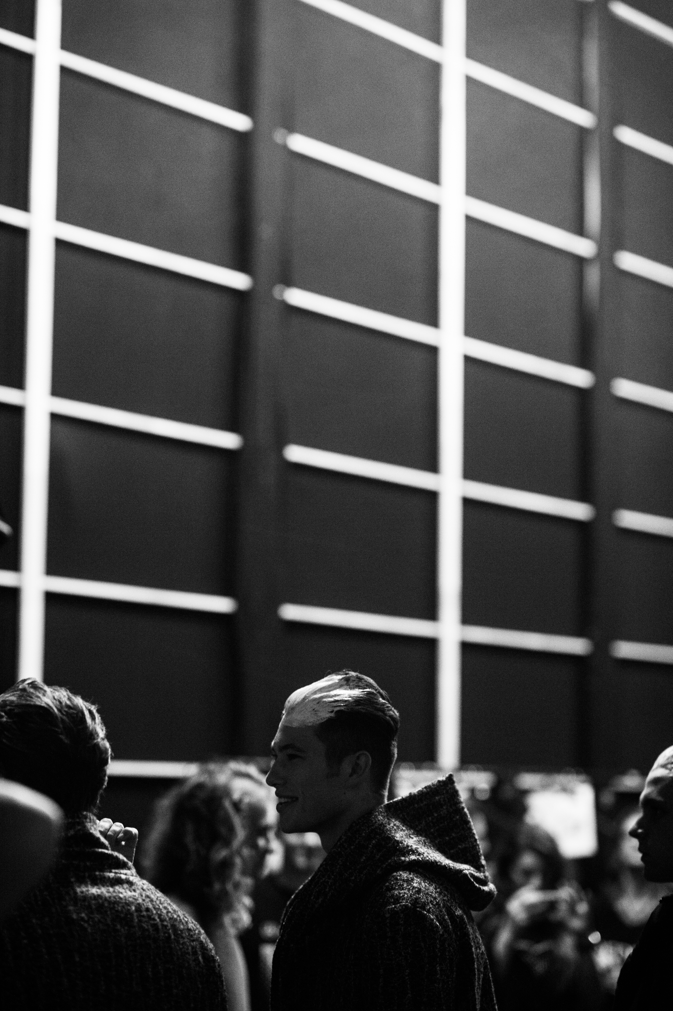 Male models lined up before a fashion show