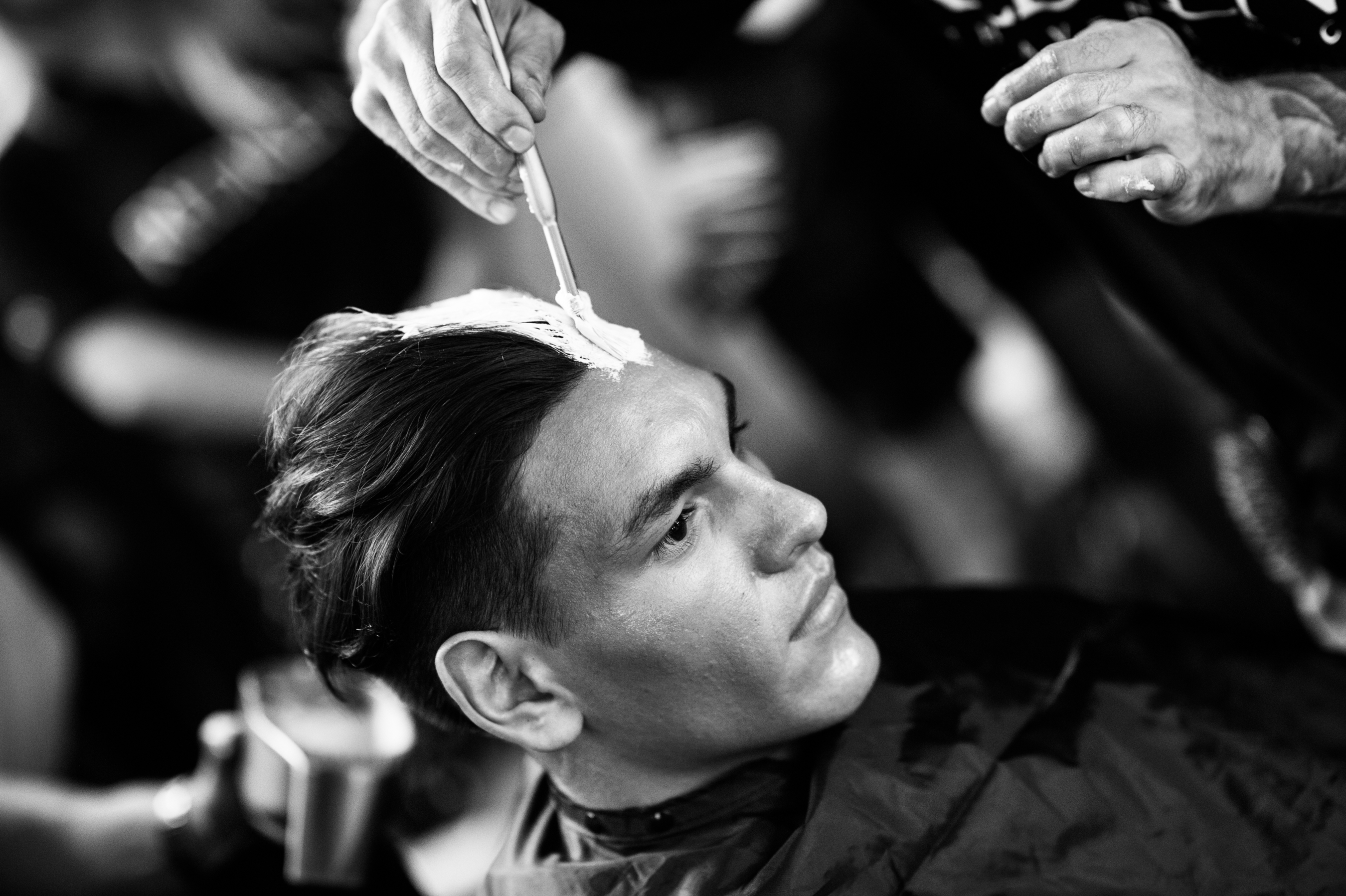 Male model getting his hair painted