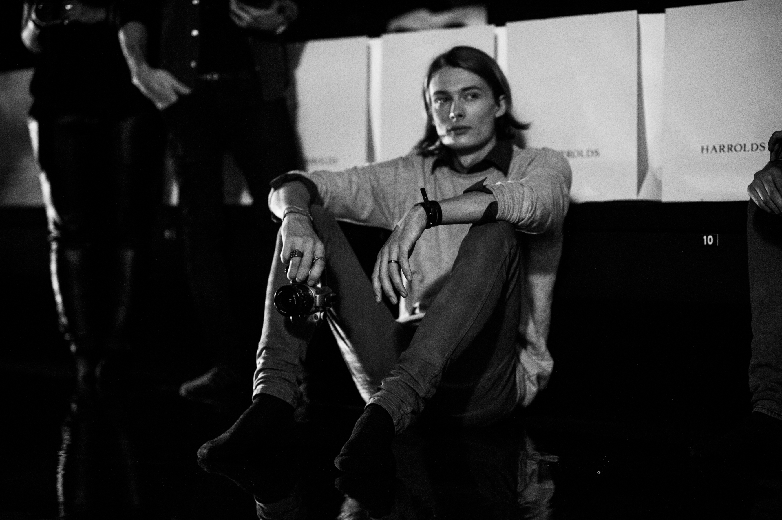 Male model sitting on the runway