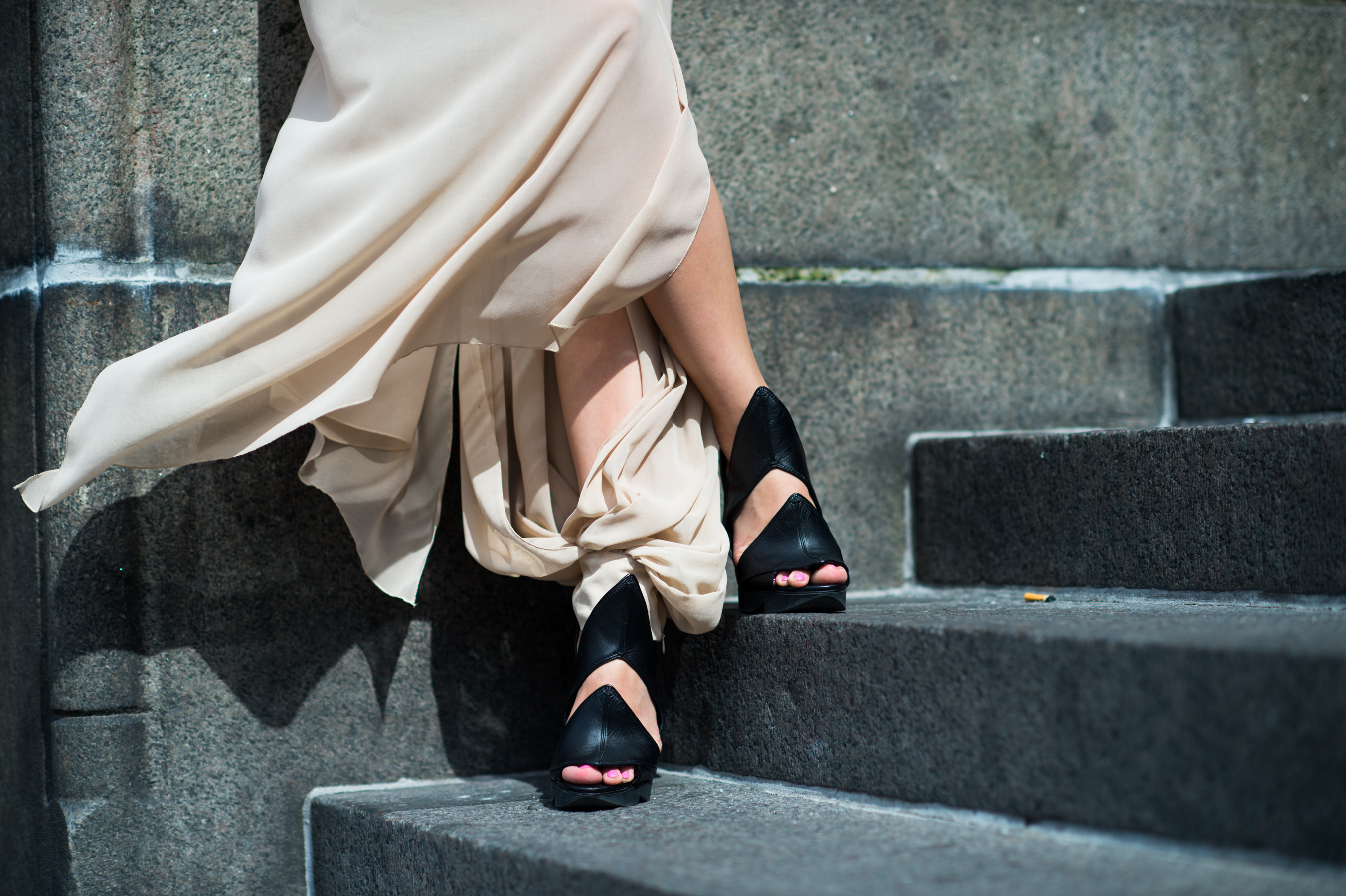 Girl wearing a nude skirt and Camilla Skovgaard shoes