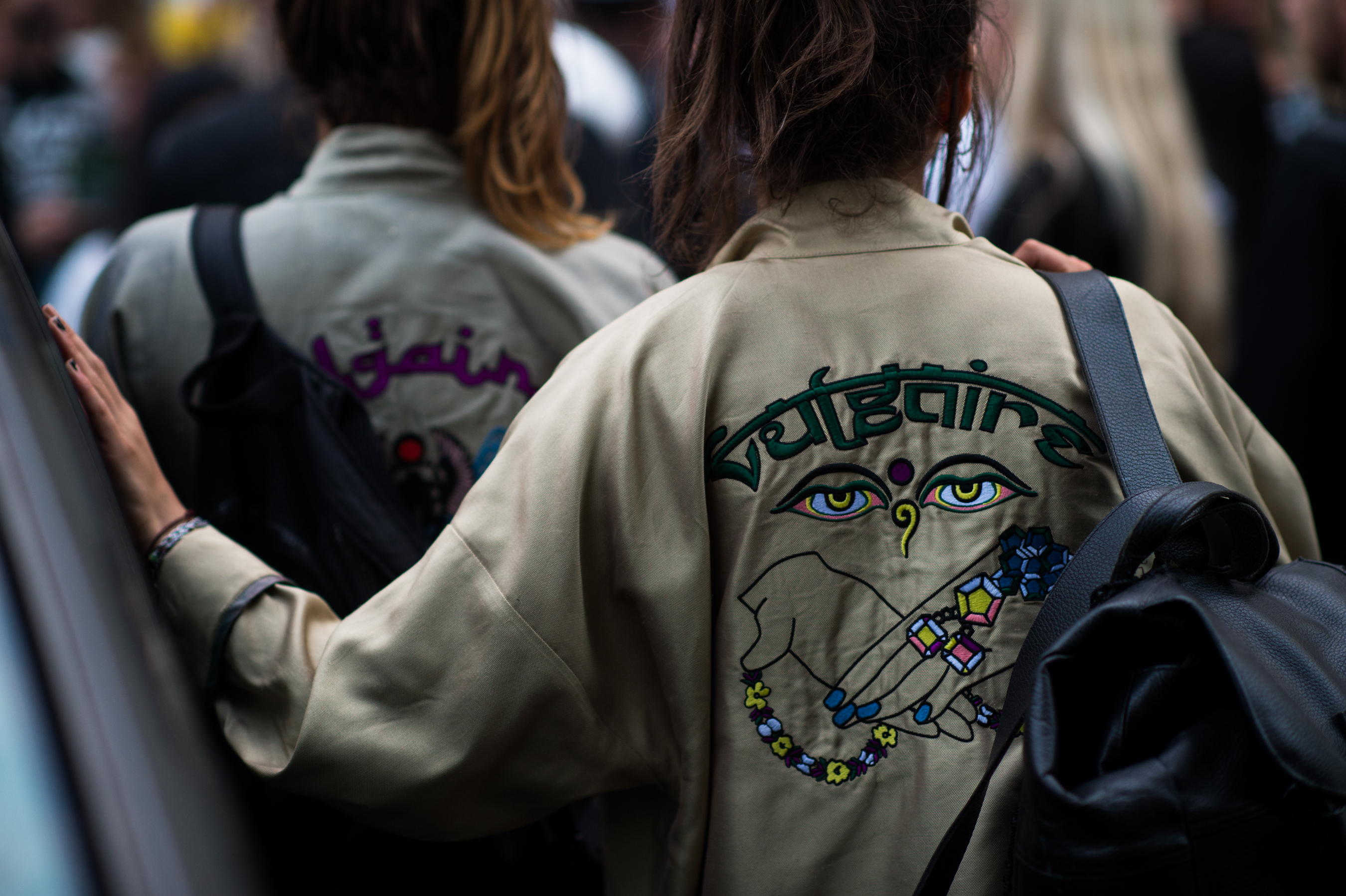 Two girls with embroidered jackets