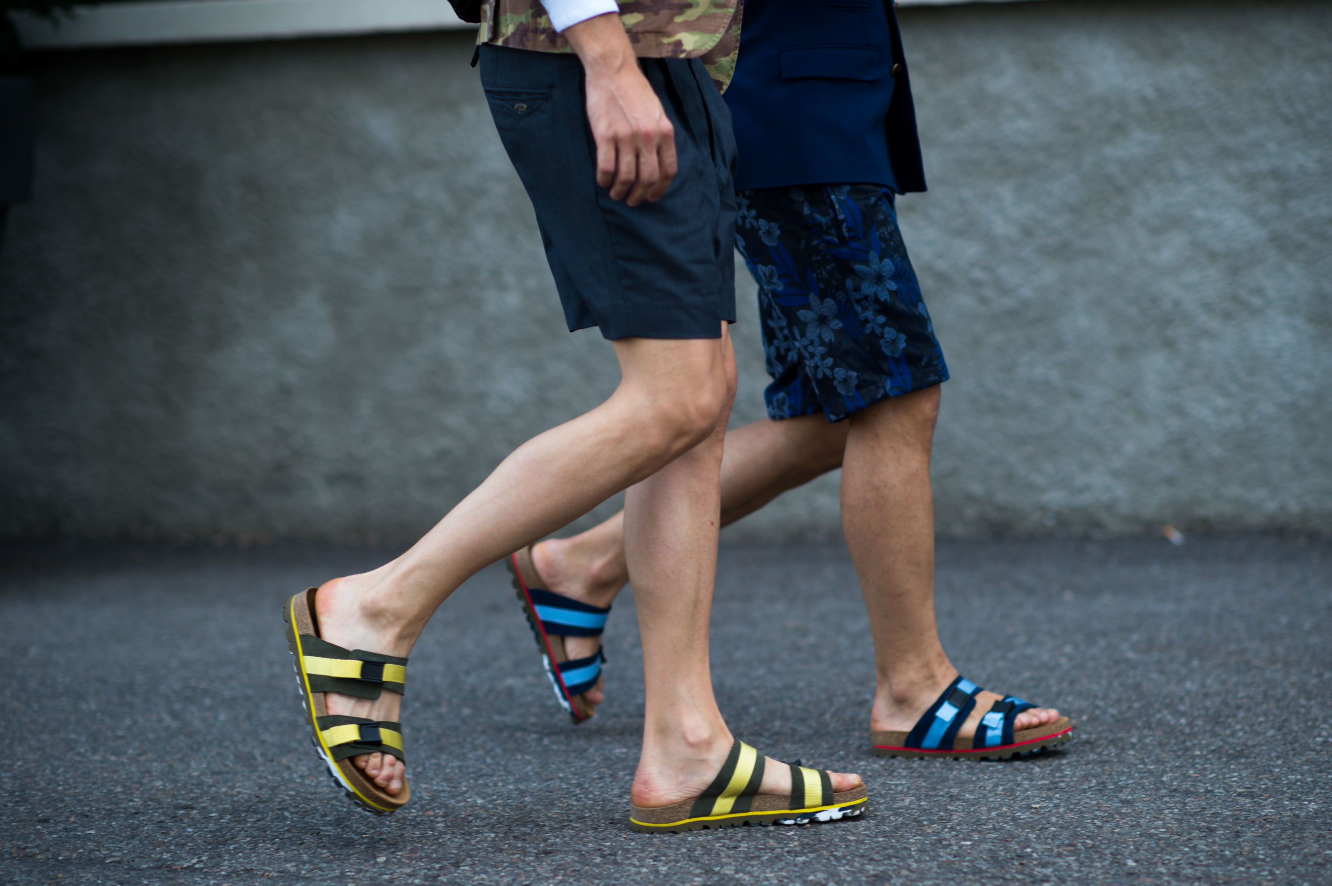 Two men wearing matching sandals