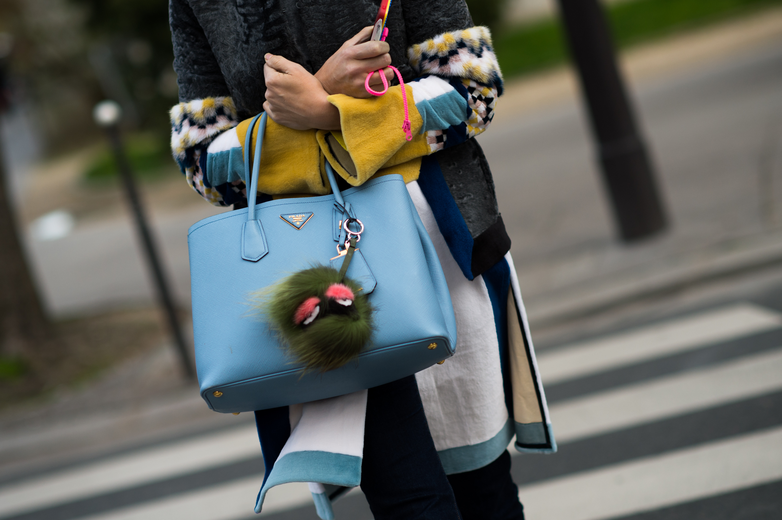 Woman with a blue Prada Saffiano bag